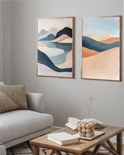 Two abstract landscape paintings on a wall above a sofa and coffee table.