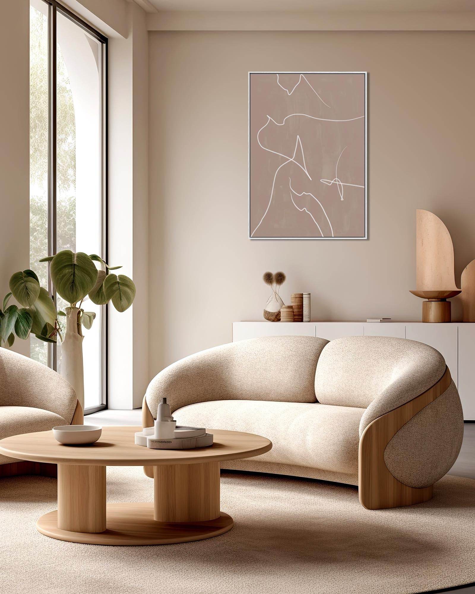 Modern living room with beige sofa, armchair, and round coffee table.