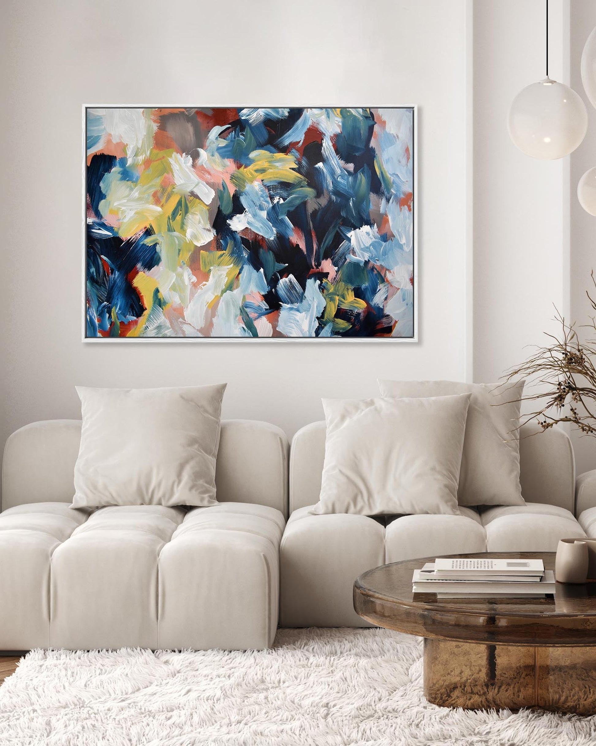 Living room with a beige sectional sofa, wooden coffee table, and abstract painting on the wall.