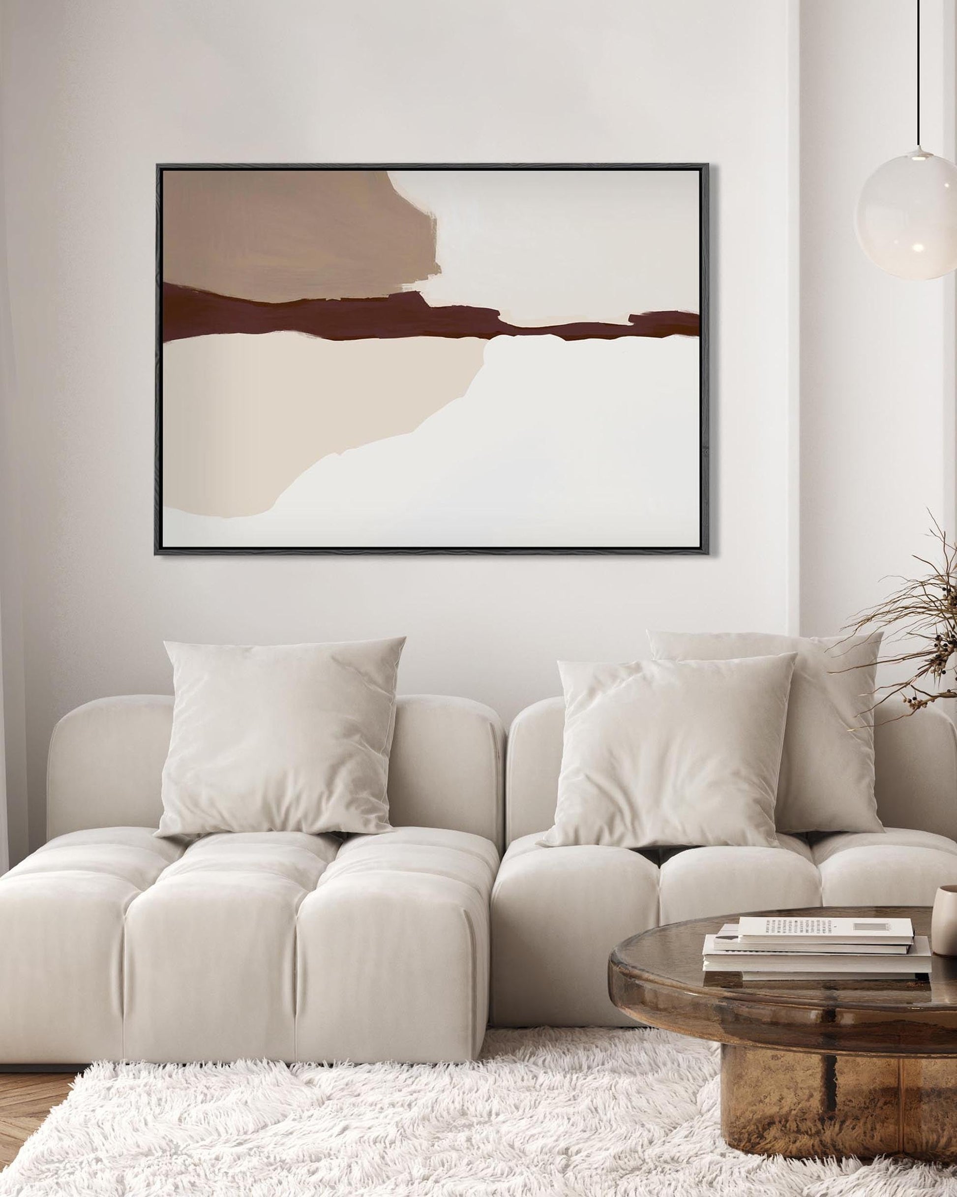 Modern living room with a neutral color palette, featuring a beige sofa, abstract art, and a wooden coffee table.