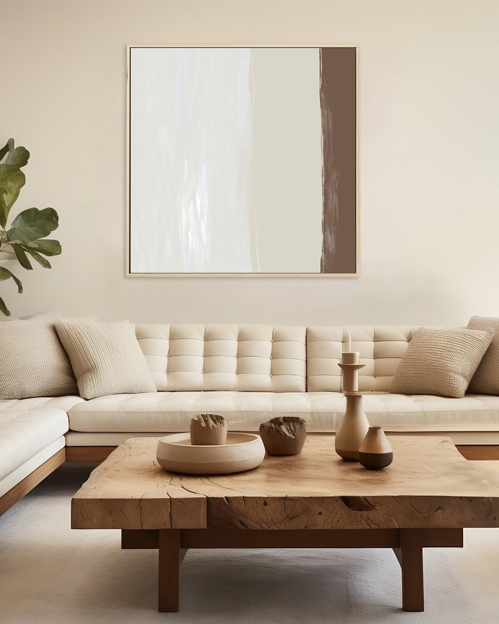 Modern living room with a beige sectional sofa, wooden coffee table, and abstract art on the wall.