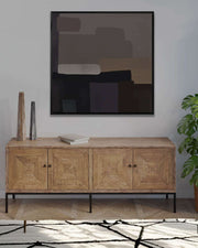 Wooden sideboard with abstract art above it in a room setting