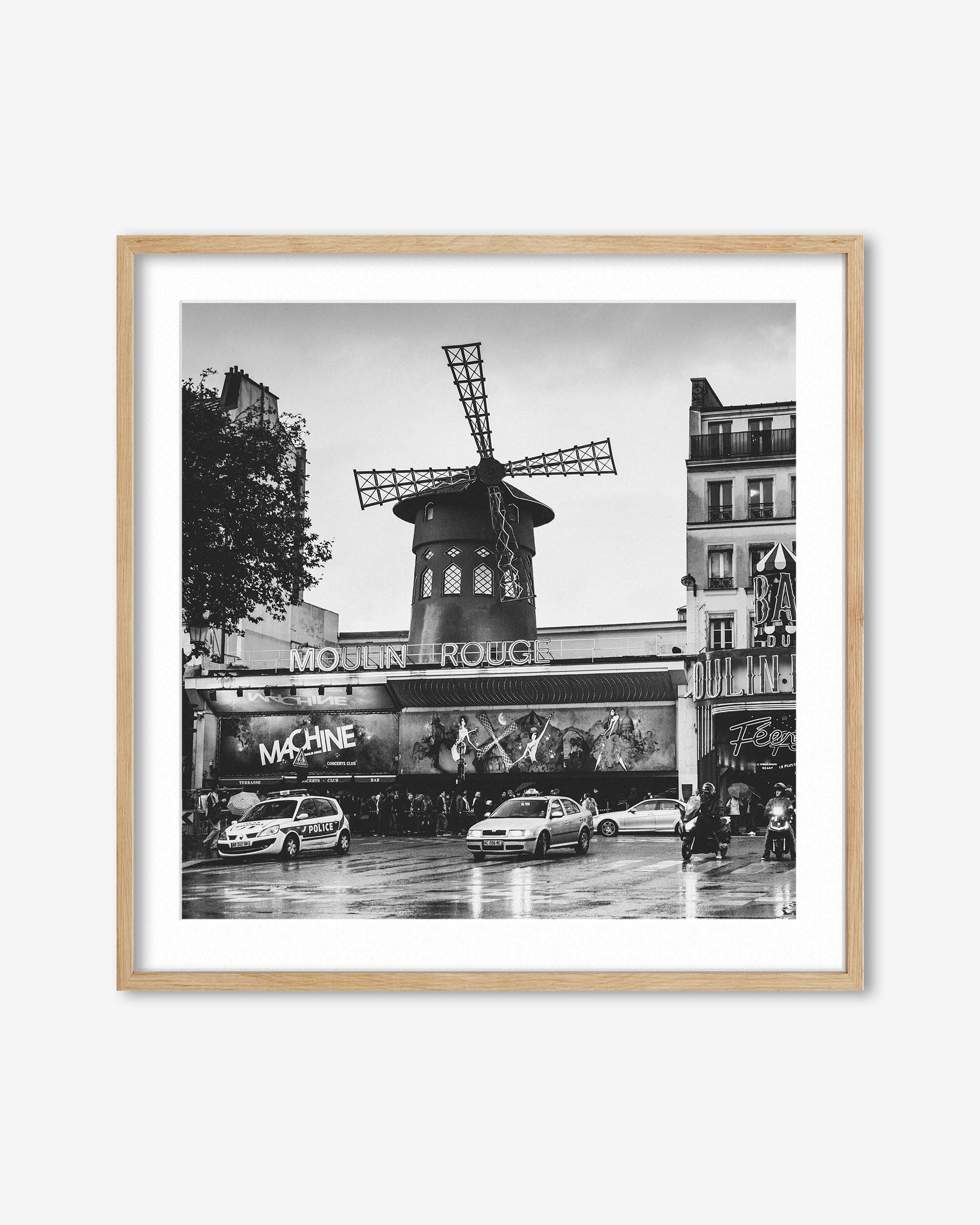 Framed black and white photo of the Moulin Rouge in Paris with a windmill.