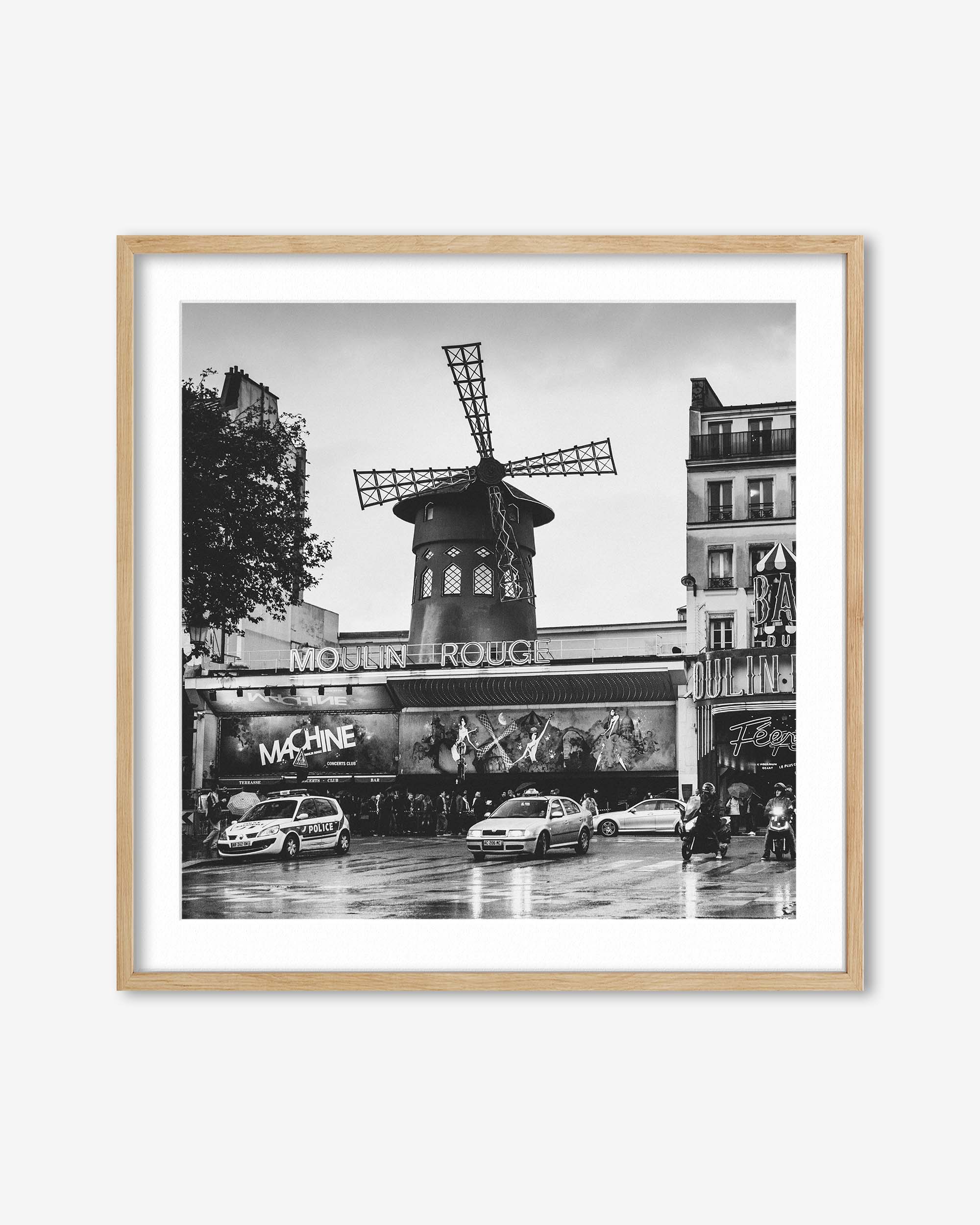 Framed black and white photo of the Moulin Rouge in Paris with a windmill.