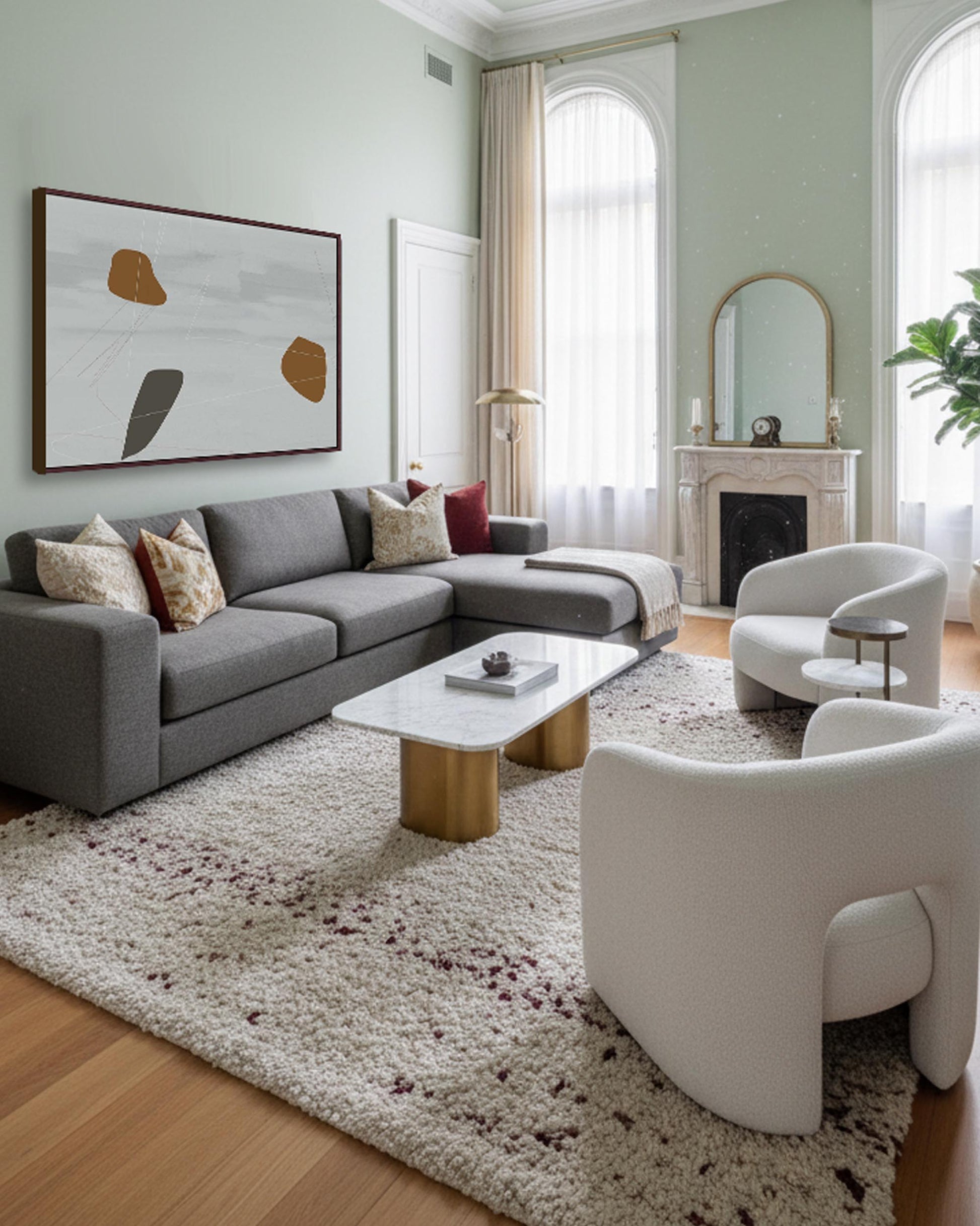 Modern living room with gray sectional sofa, white chairs, and abstract art on light green walls.