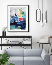 Modern living room with abstract art on the wall, a sofa, and decorative items.