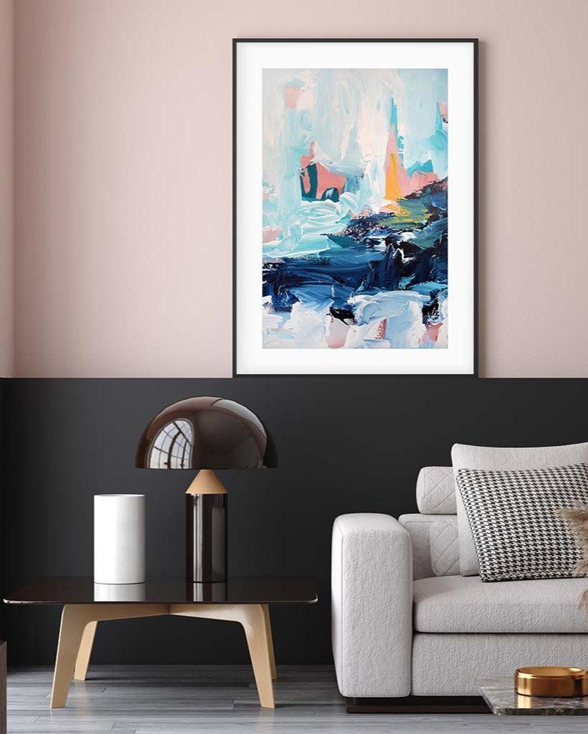 Modern living room with abstract art on the wall, a sofa, and decorative items.