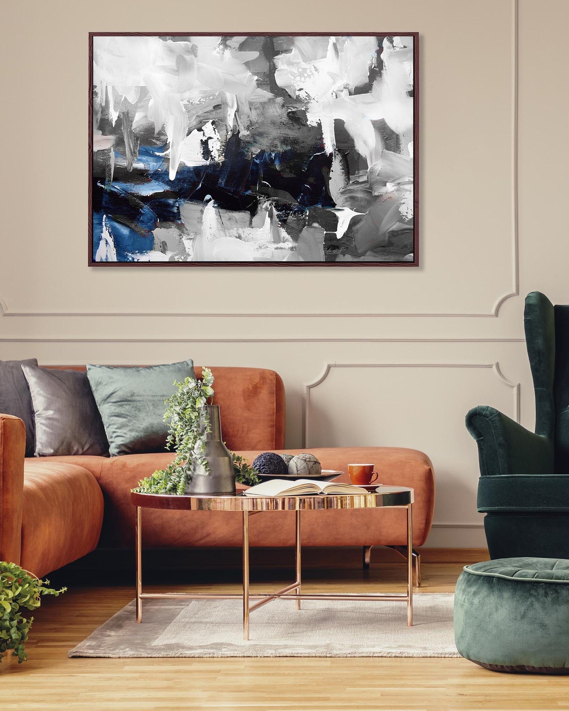 Living room with abstract painting on the wall, brown sofa, and green armchair.