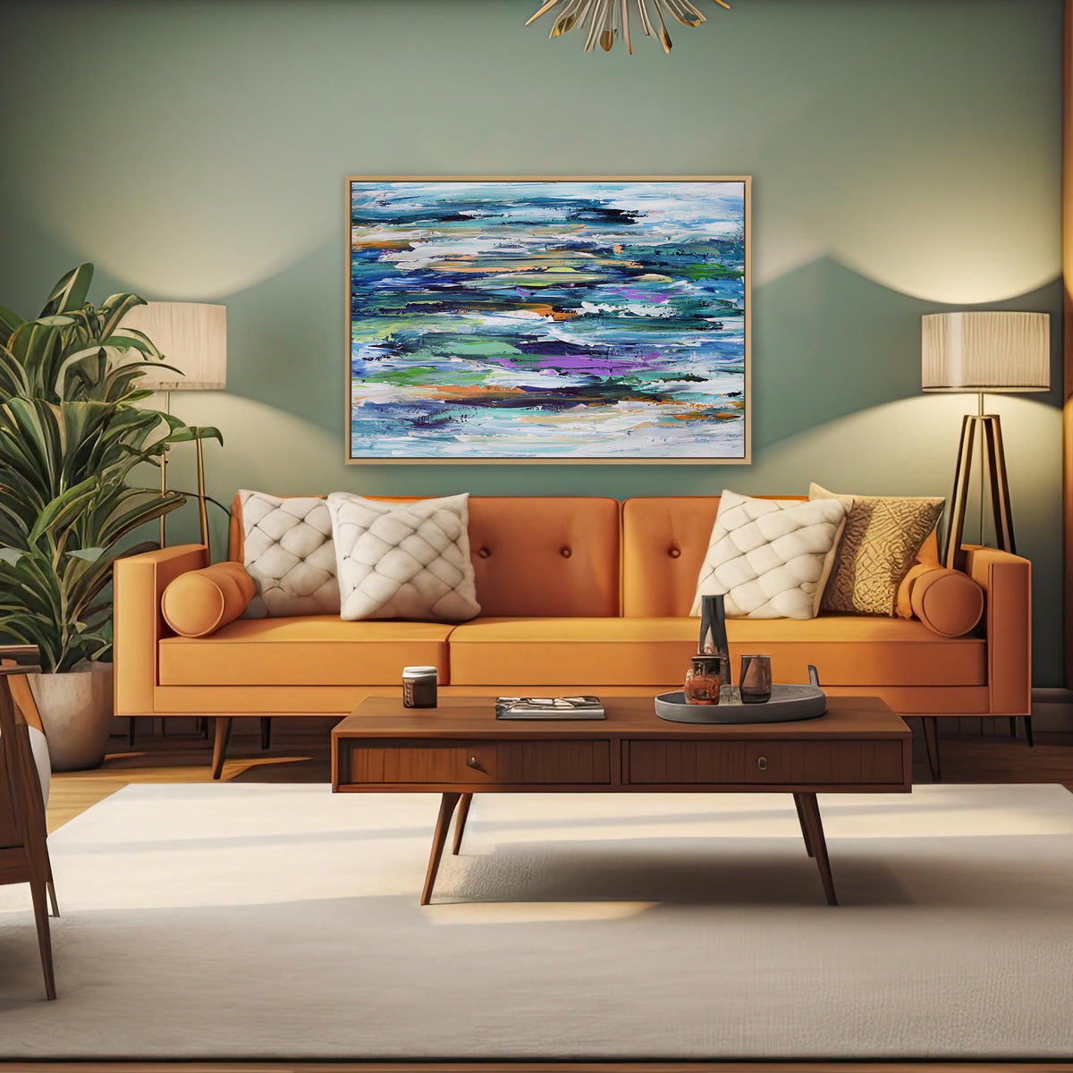 A styled living room featuring a prominent square abstract canvas painting with blue, green, and purple tones, hung on a sage green wall above a modern orange sofa with decorative pillows.