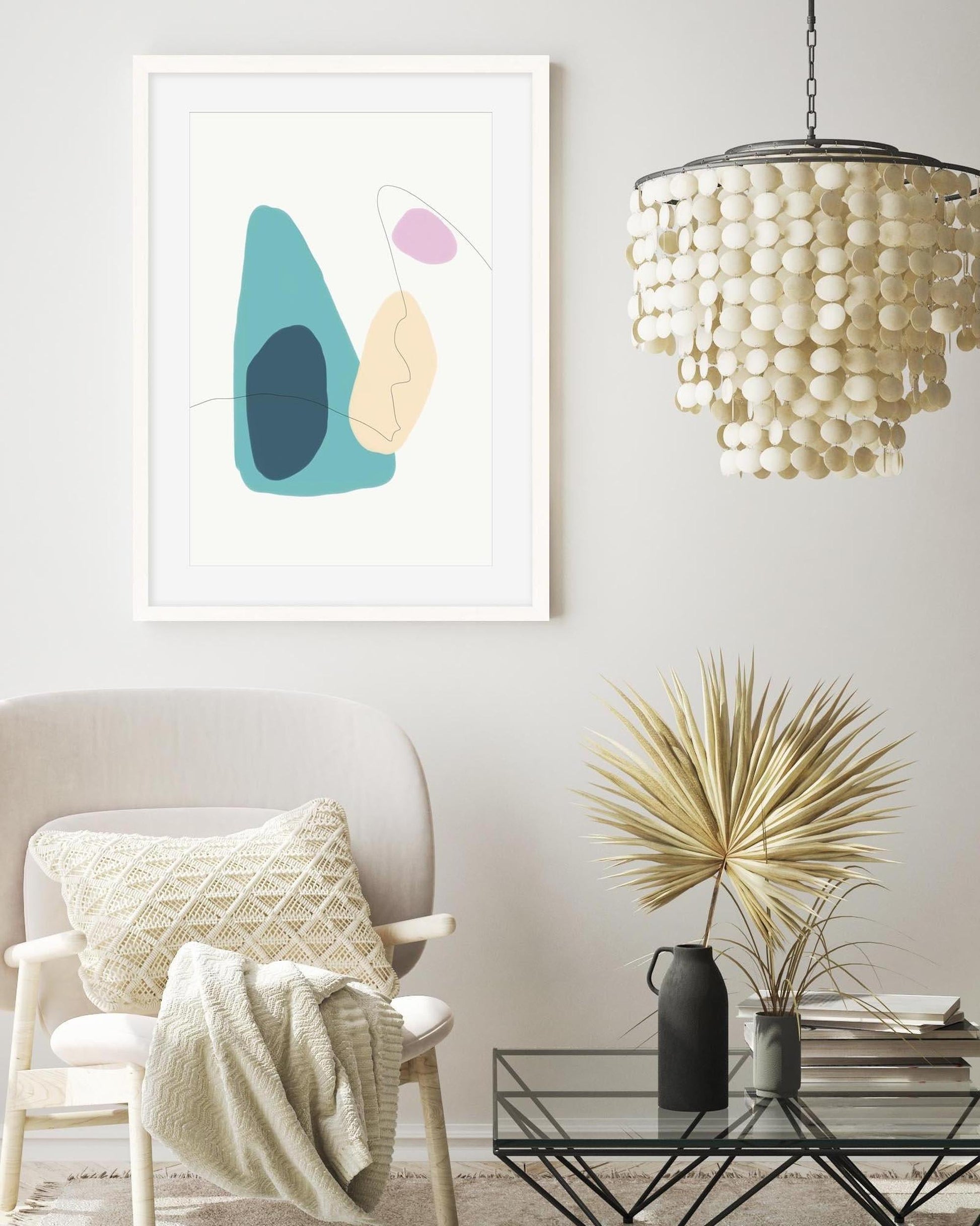 Modern living room with abstract art, chair, and decorative items.