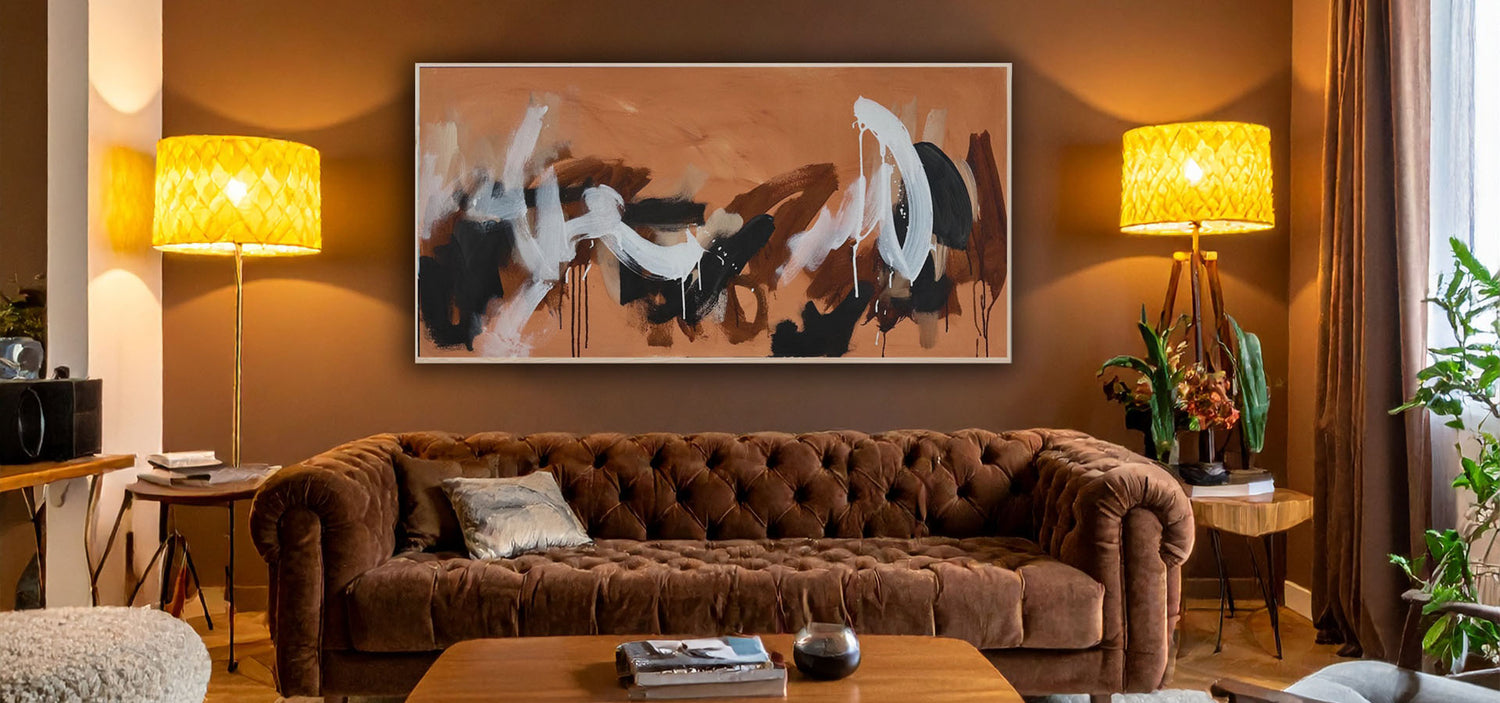modern living room with brown aesthetic Chesterfield sofa, large modern earthy abstract painting on the wall and contemporary plants and accessories.