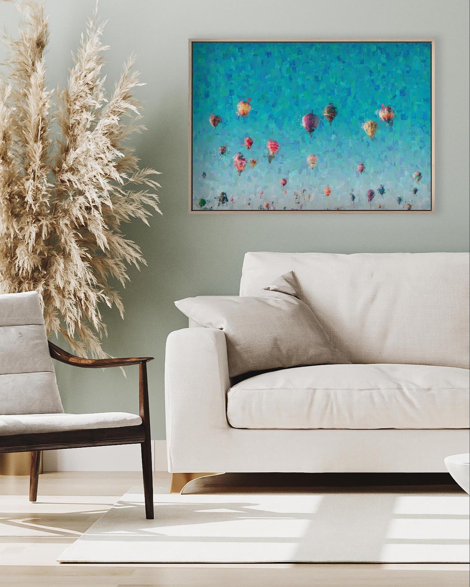 Modern living room with a white sofa, armchair, and decorative plant.