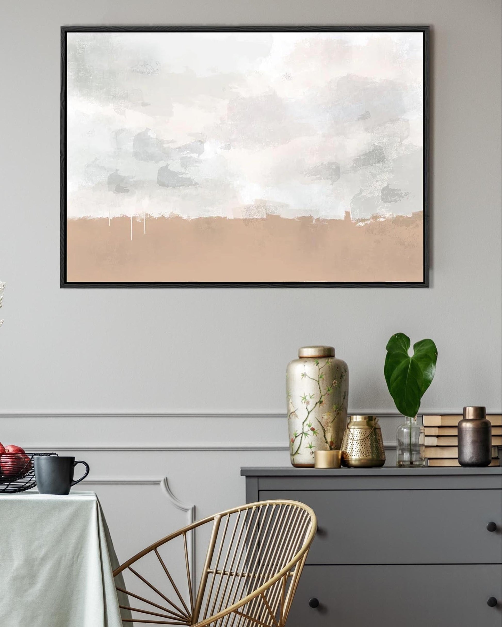 Abstract painting on a wall above a table with decorative items