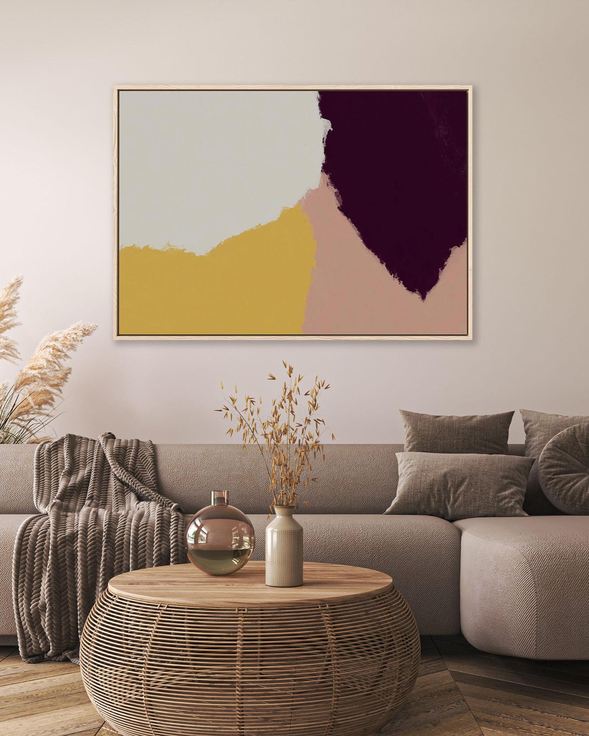 Modern living room with a gray sofa, abstract art, and decorative items.