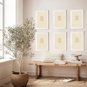 a set of 6 framed prints on the wall above a bench in a styled room with a potted tree