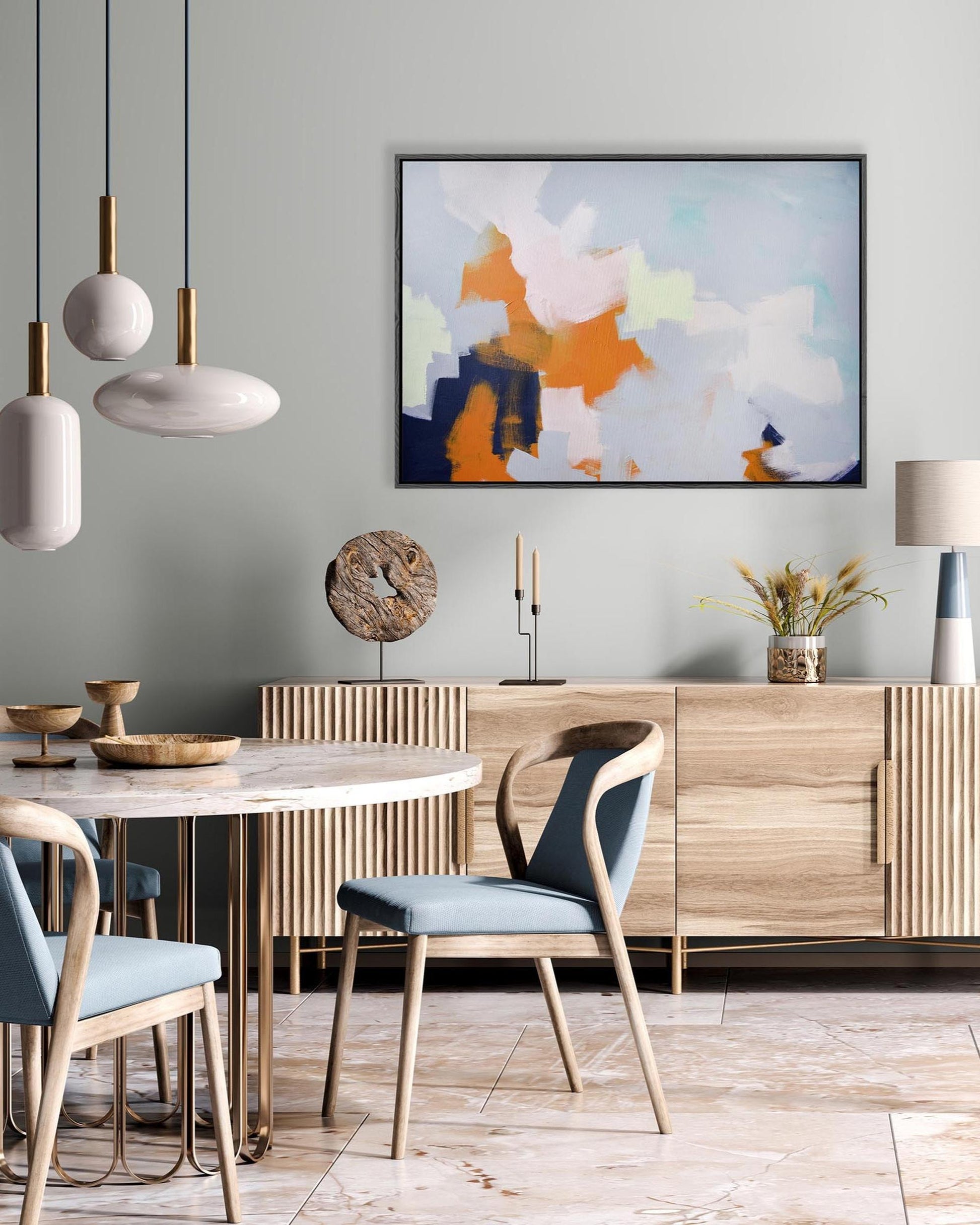 Dining room with wooden table, chairs, and abstract art on the wall.