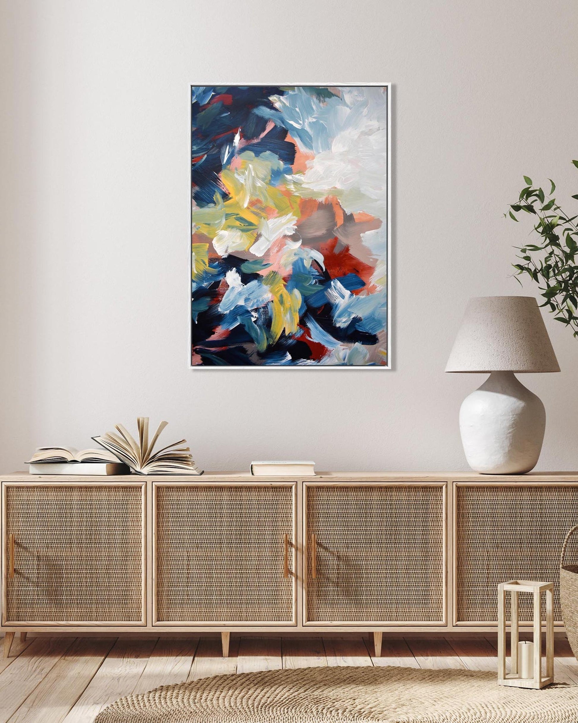 Modern living room with a sideboard, abstract painting, and decorative items.