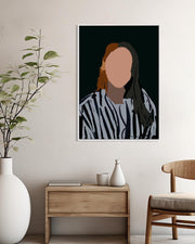 Framed portrait on a wall above a wooden side table with decorative items.