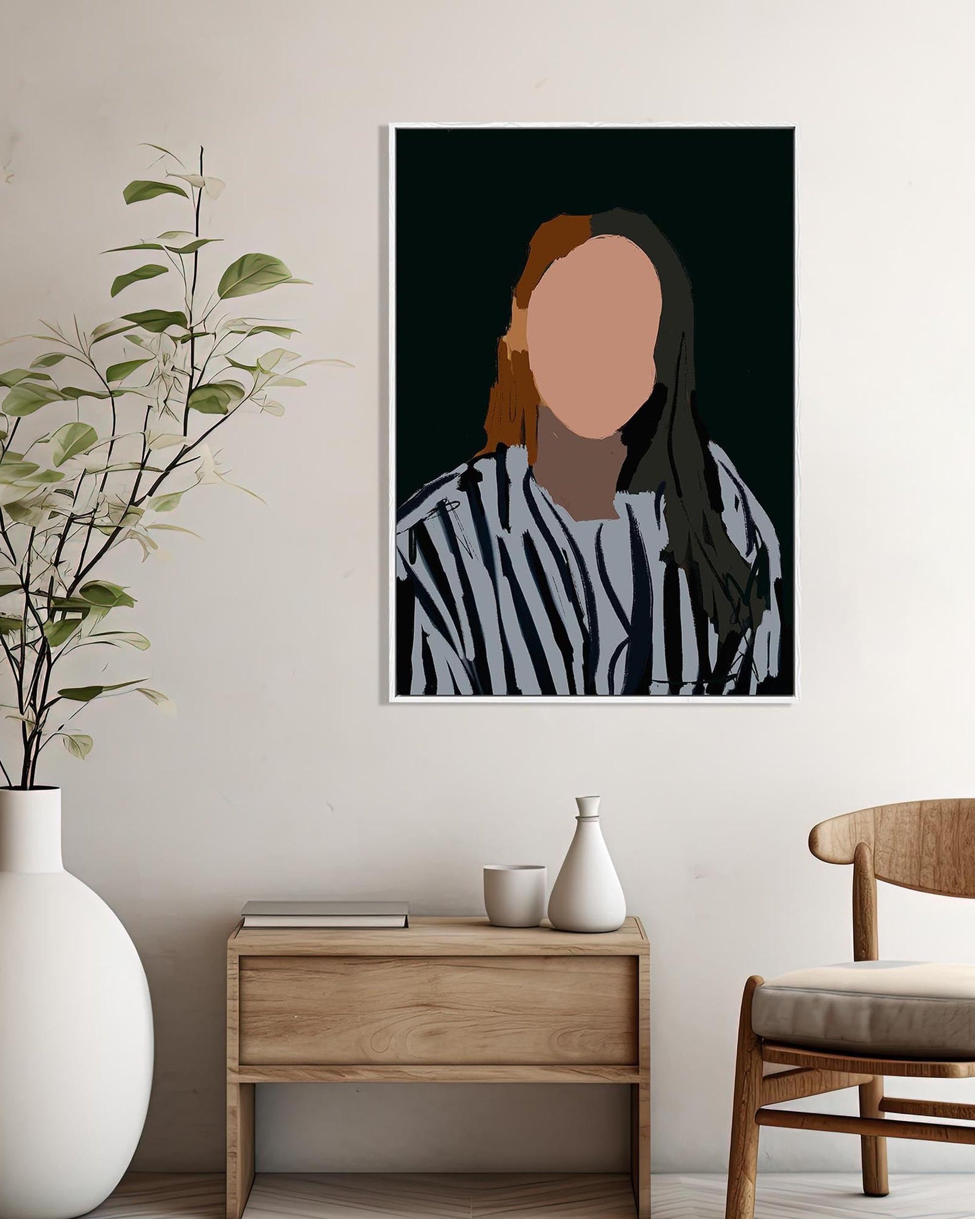 Framed portrait on a wall above a wooden side table with decorative items.