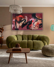 Modern living room with a green sofa, wooden coffee table, and large pink bold expressive abstract painting on the wall.