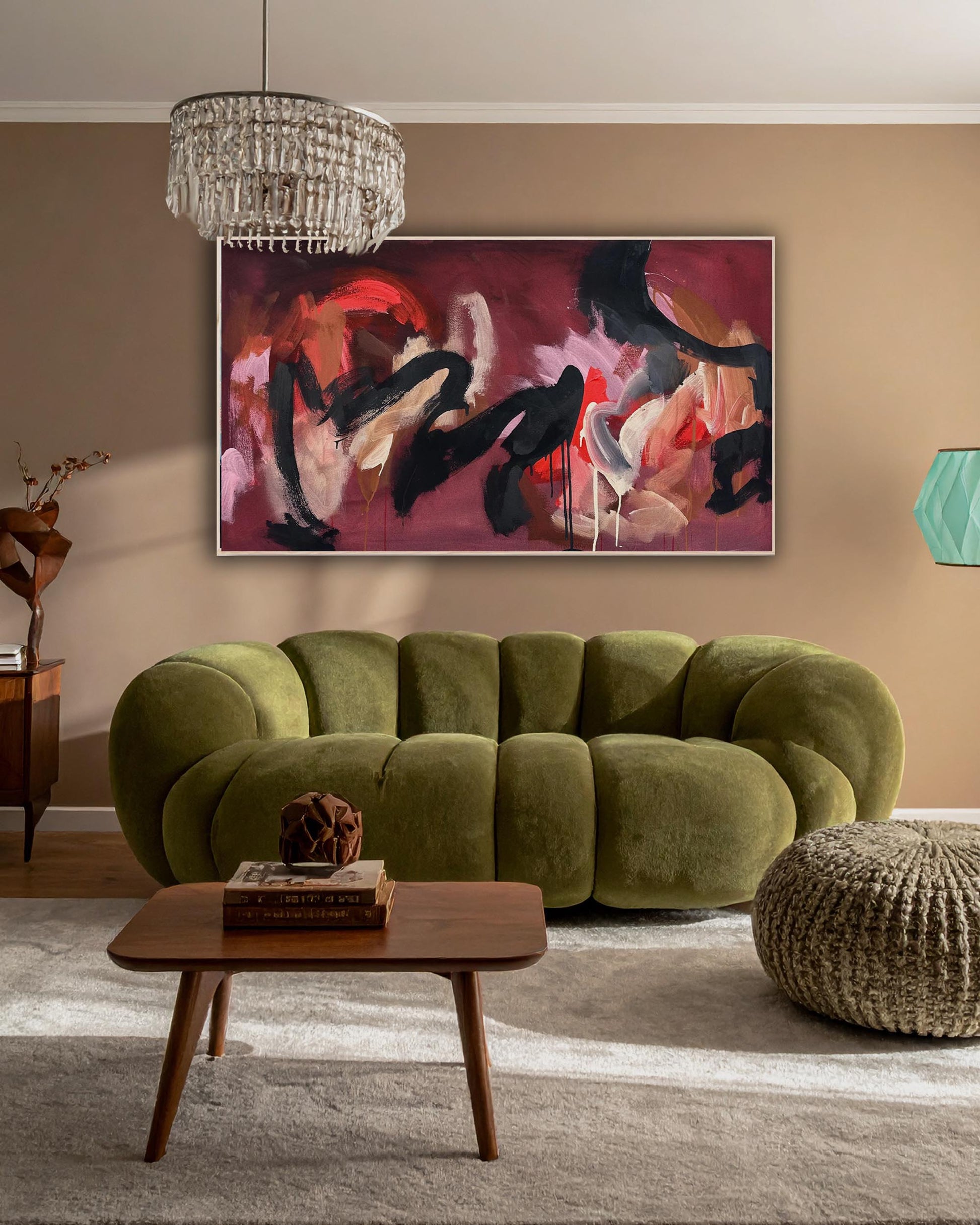 Modern living room with a green sofa, wooden coffee table, and large pink bold expressive abstract painting on the wall.