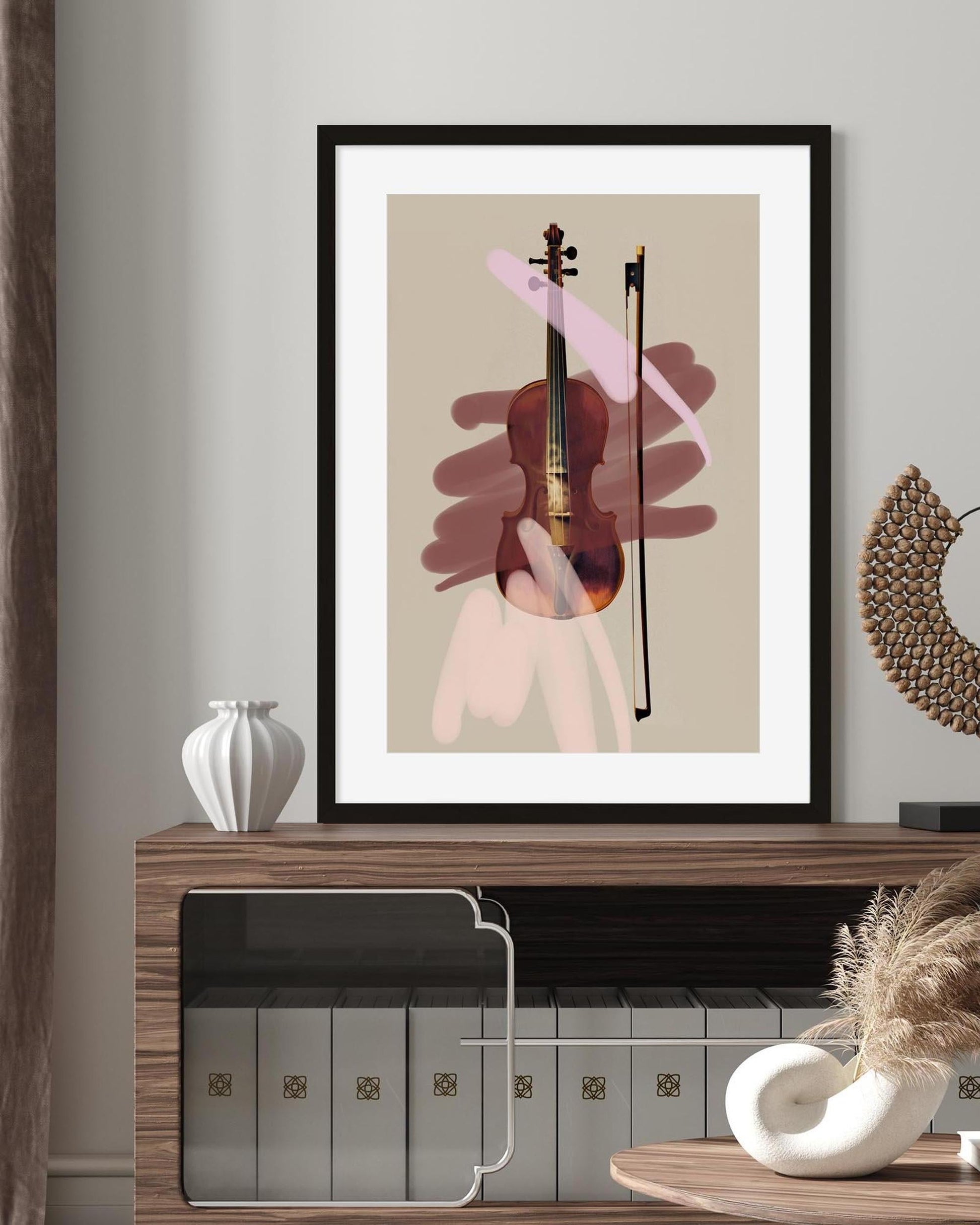 Framed abstract art of a violin on a wall above a wooden shelf.