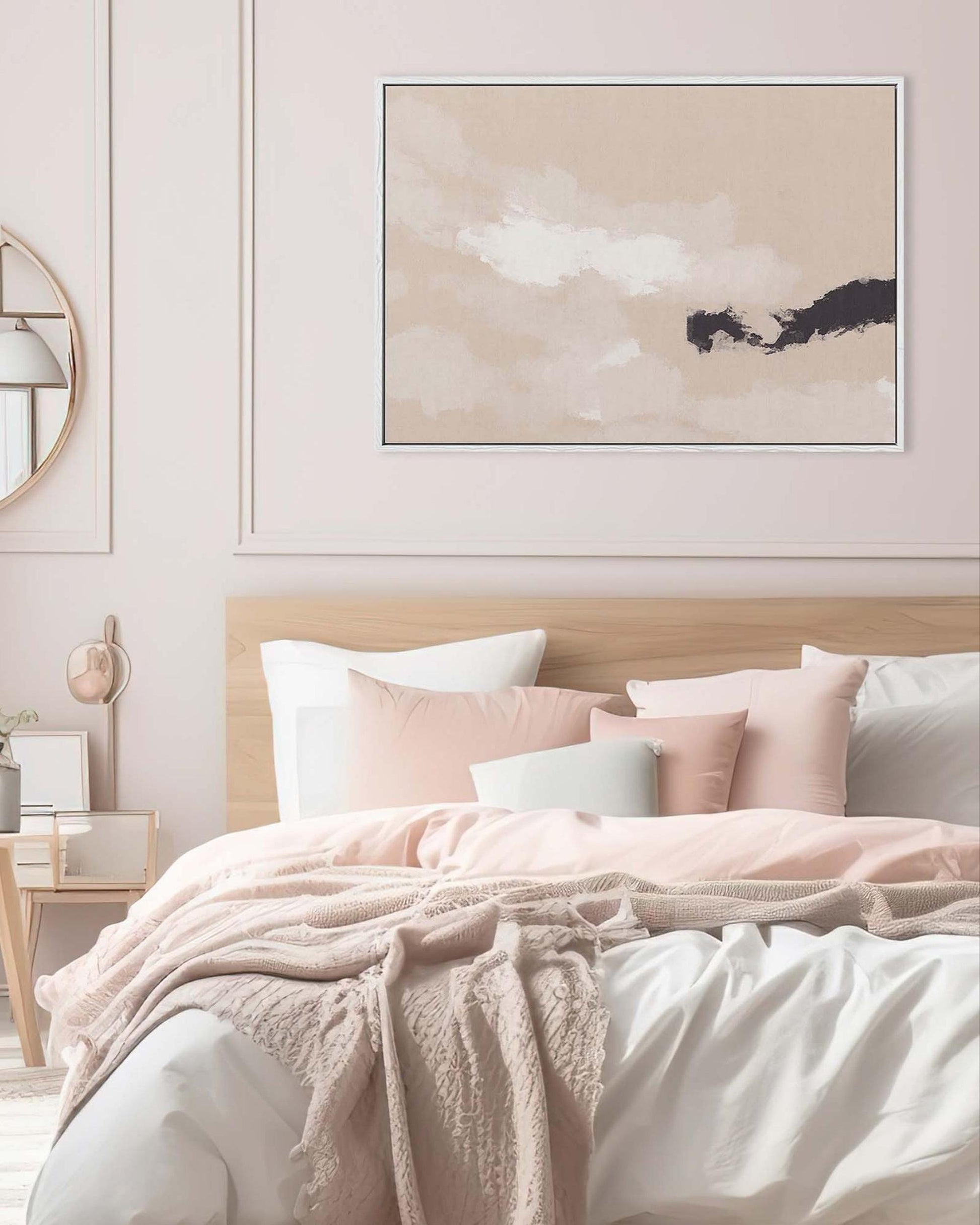 Neatly made bed with pink and white bedding in a bedroom setting, featuring a framed abstract art piece on the wall.