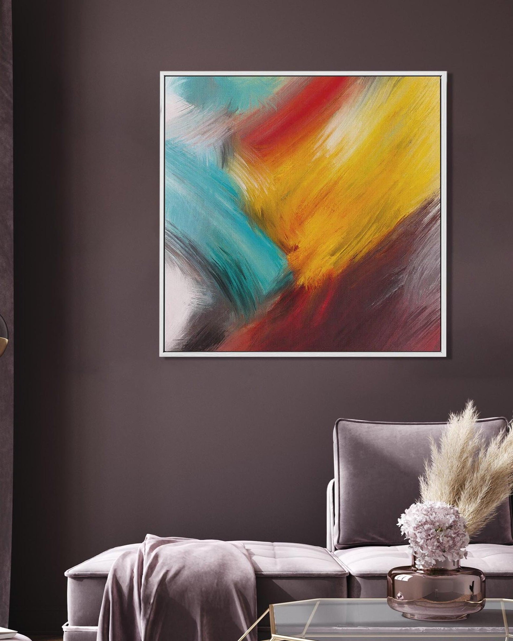 Abstract painting with vibrant colors on a dark wall above a gray sofa.