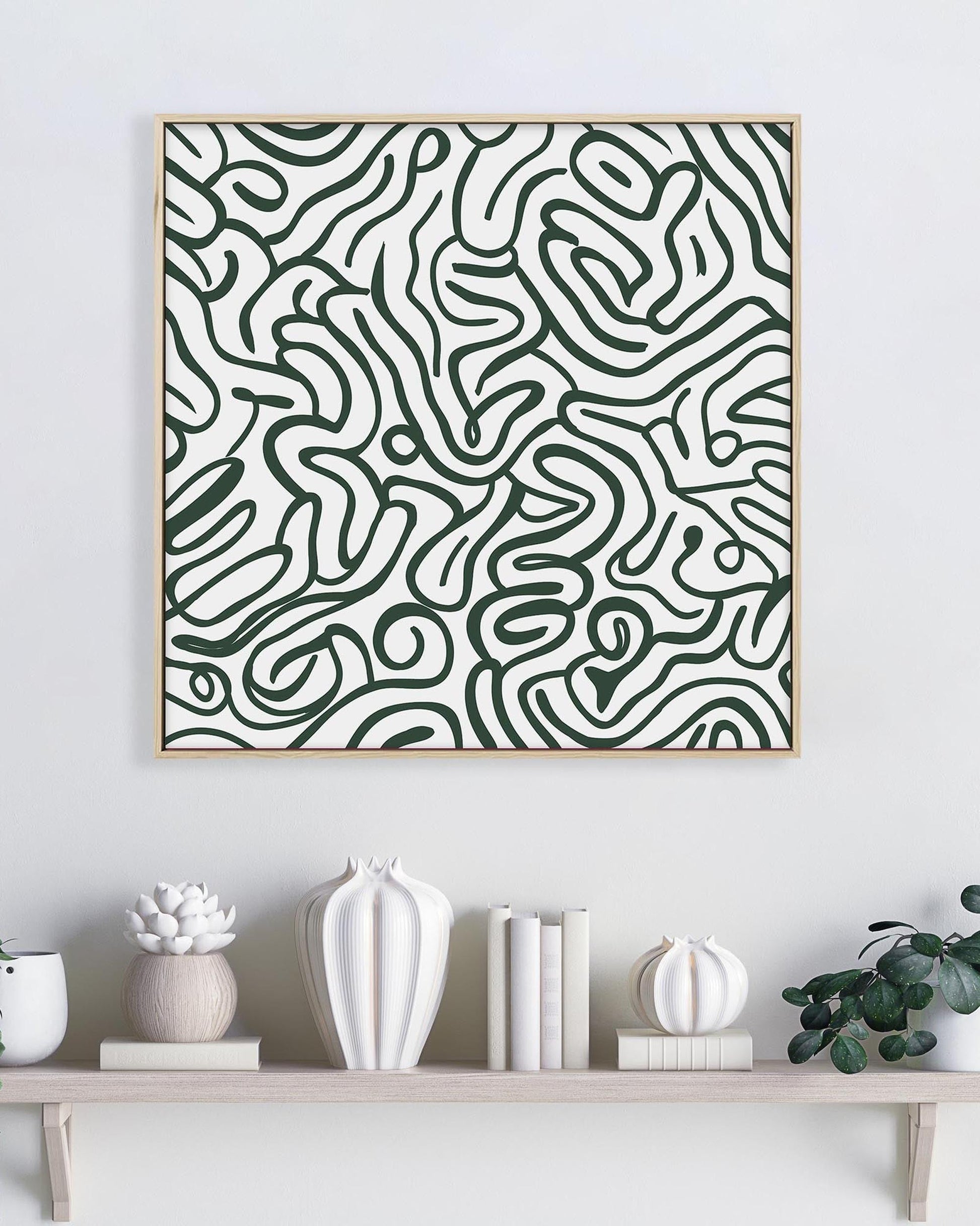 Abstract patterned artwork on a wall above a shelf with decorative items.