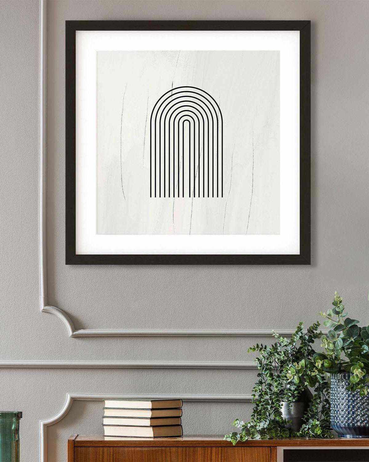 Framed abstract art print on a wall with decorative items below