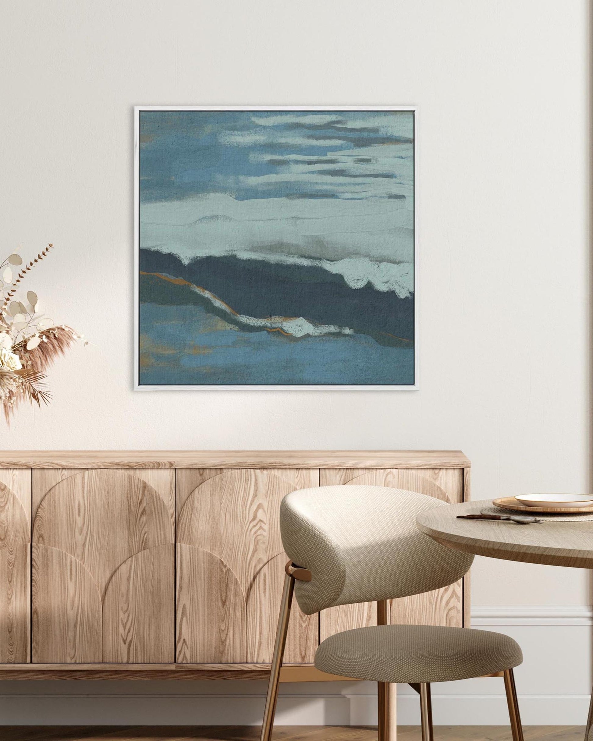 Dining room with wooden sideboard, round table, and abstract painting on wall