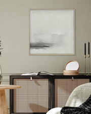 Modern interior with a framed abstract painting, wooden side table, and decorative items.