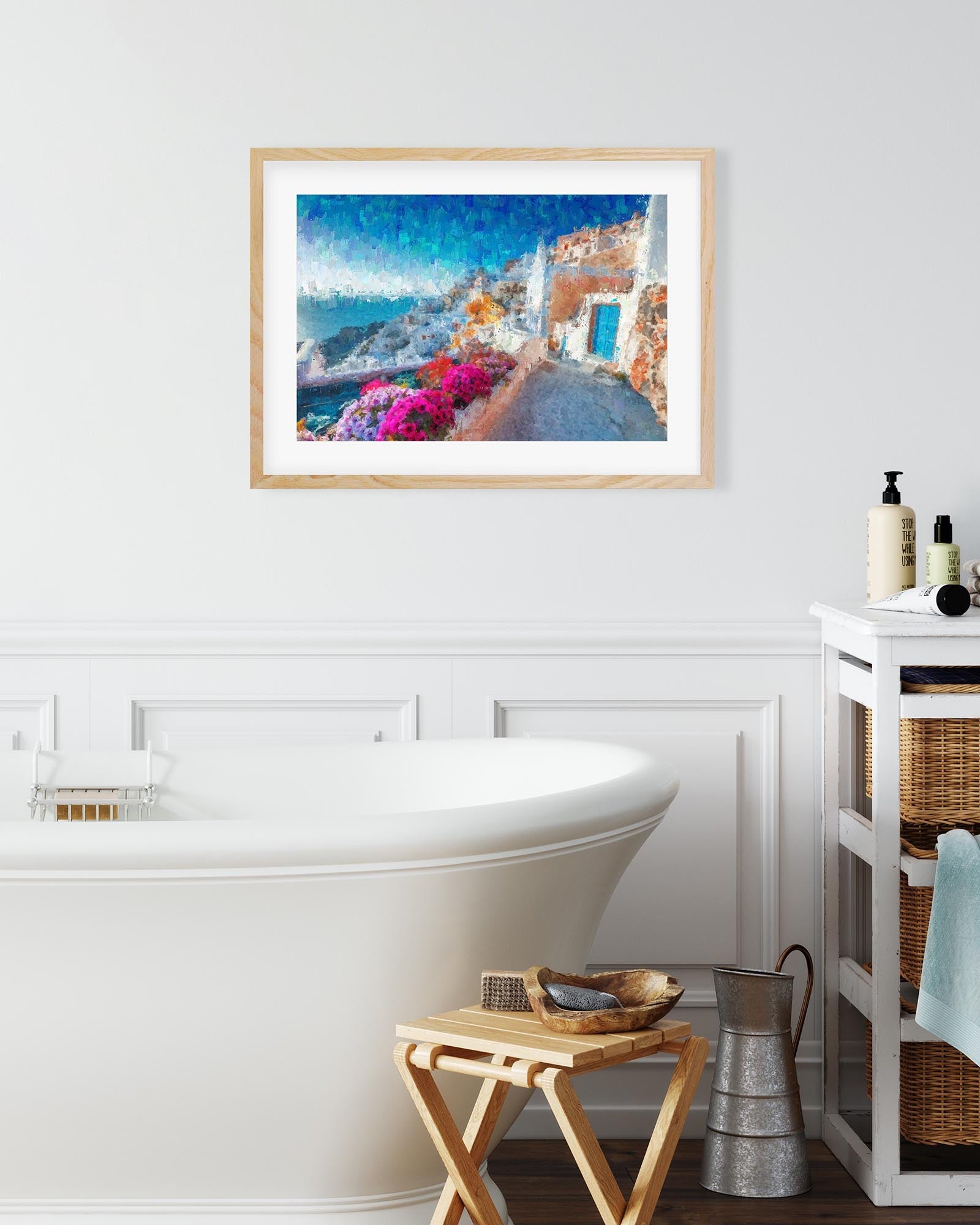 Bathroom interior with a framed artwork of a coastal scene, a bathtub, and a cabinet.