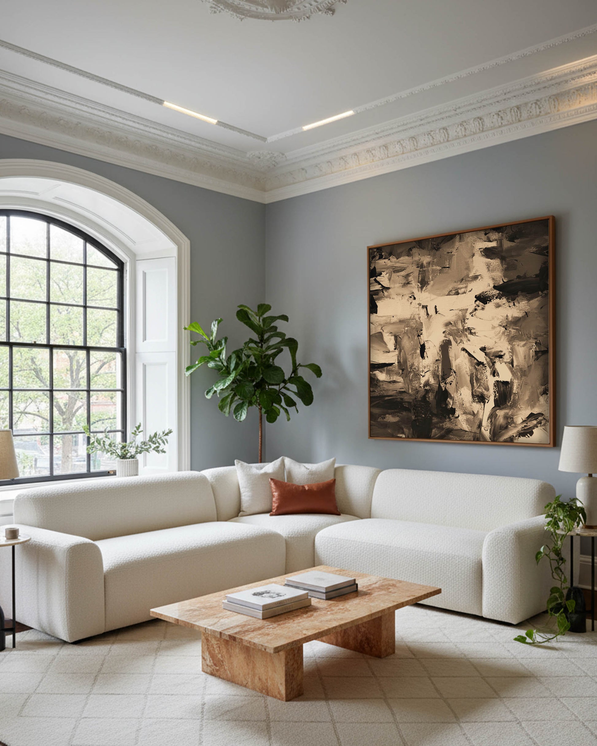 Modern living room with a white sofa, wooden coffee table, and abstract art on the wall.