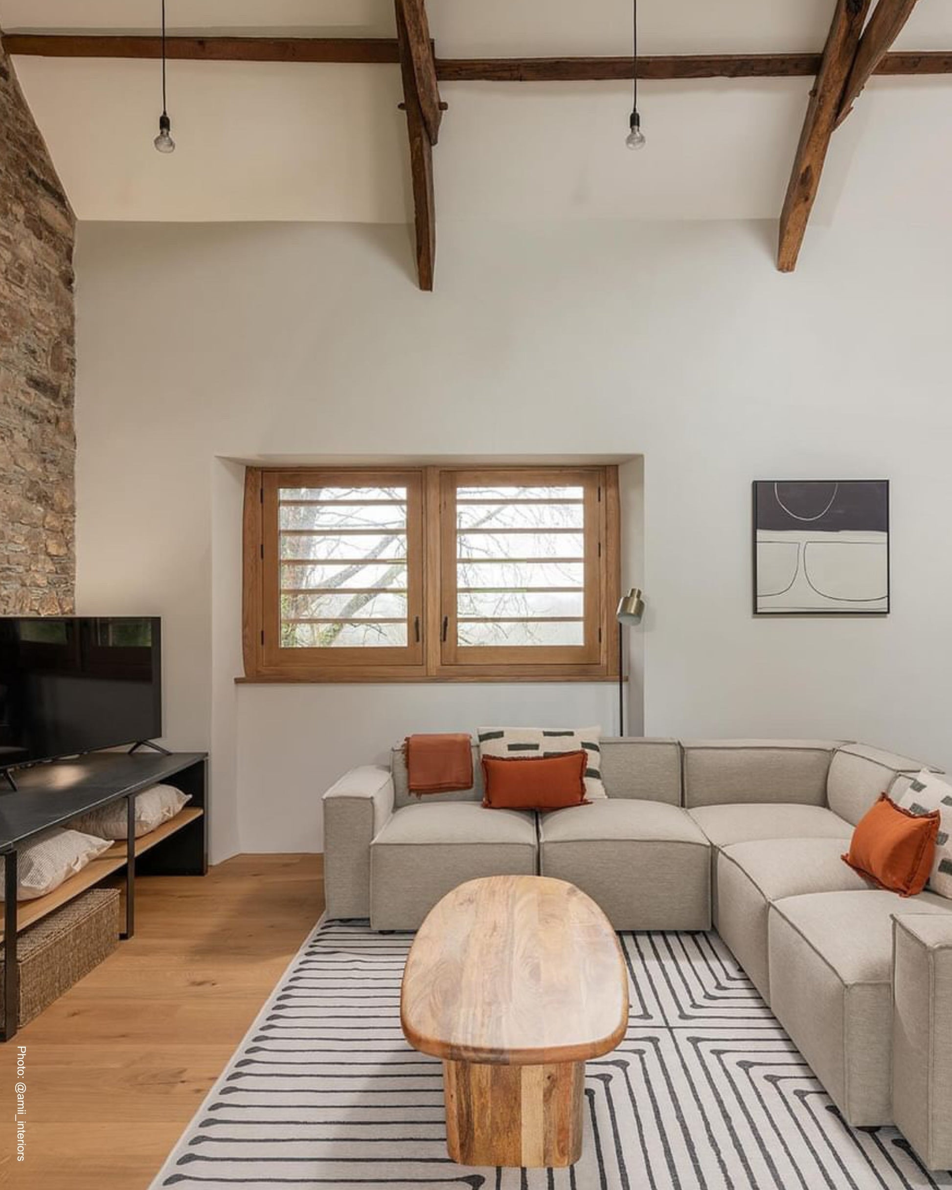Modern country home barn conversion with neutral Scandinavian abstract wall art on wall with high ceilings.