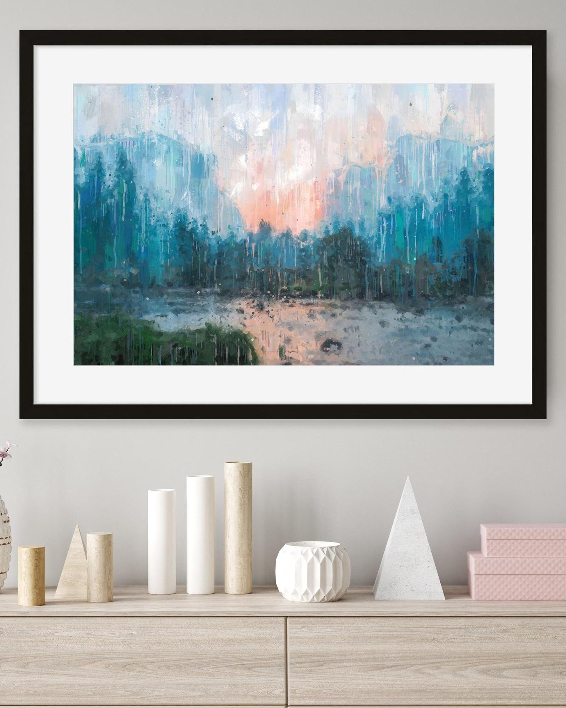 Framed abstract landscape painting on a wall above a wooden shelf with decorative items.