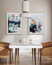 Dining room with abstract art on the wall, a glass table, and wooden chairs.