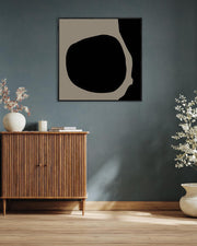 Modern interior with wooden cabinet, abstract art, and decorative plants against a dark wall.