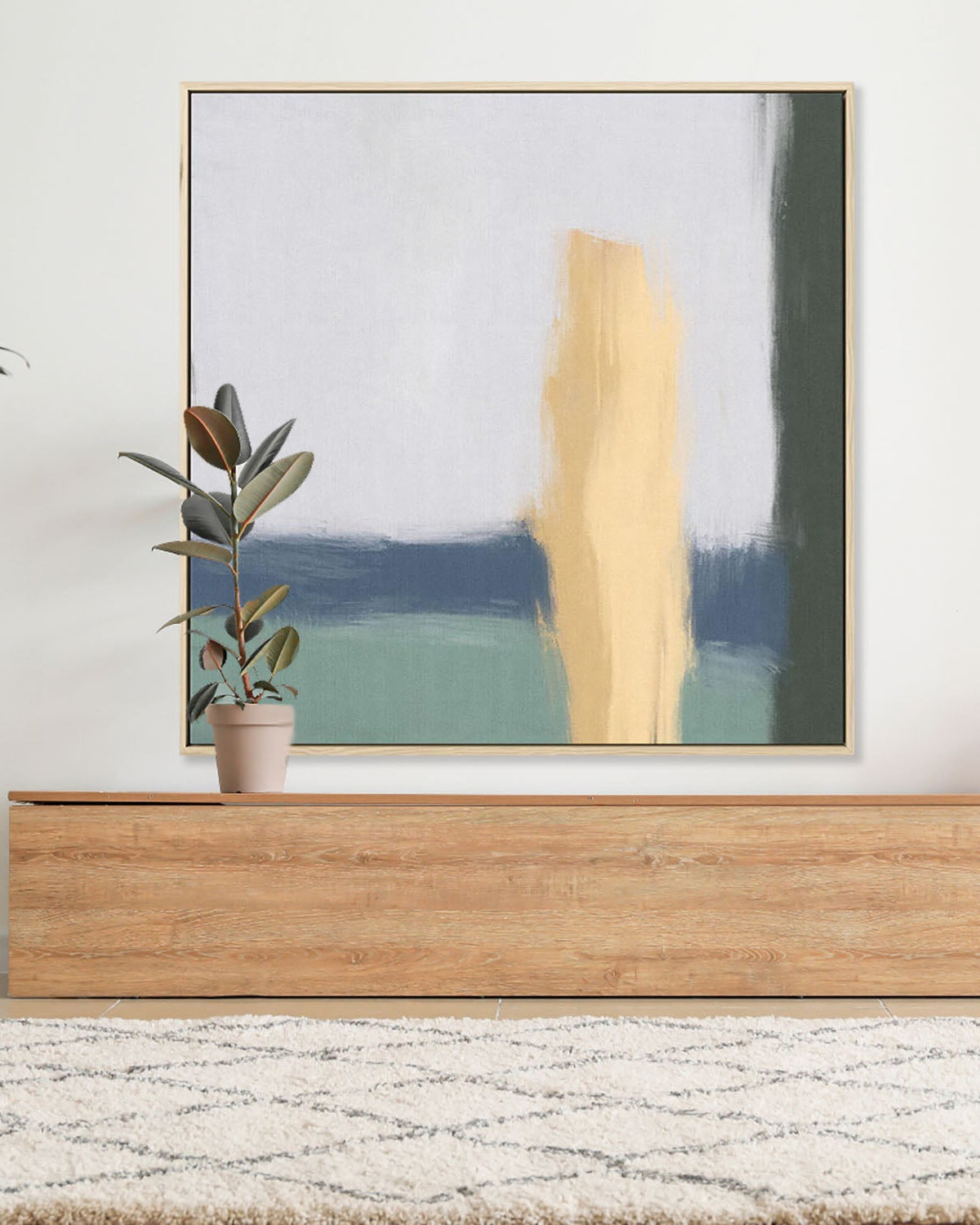 Abstract painting on a wall above a wooden console table with a plant.