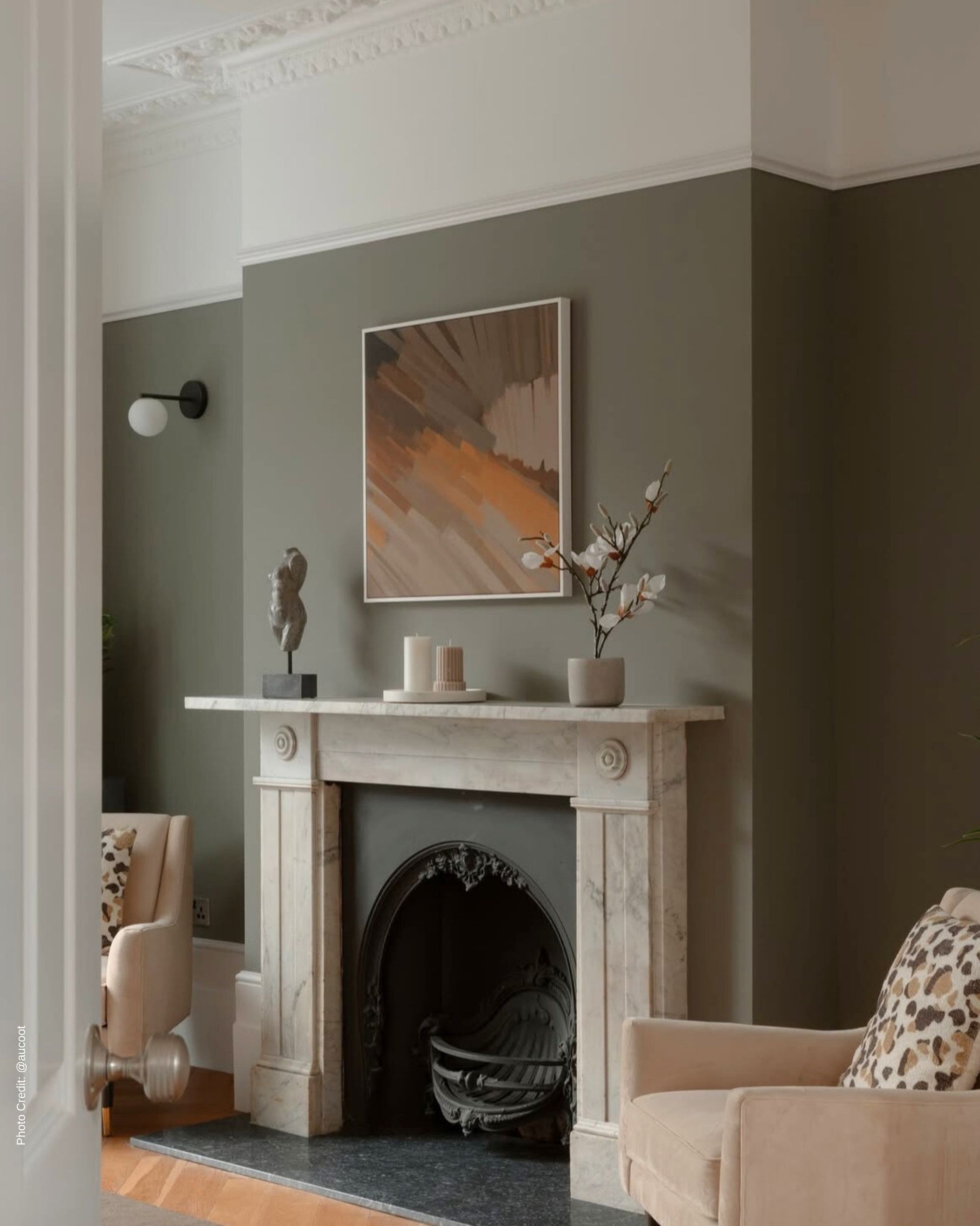 Living room with wooden fireplace and abstract art on gray wall