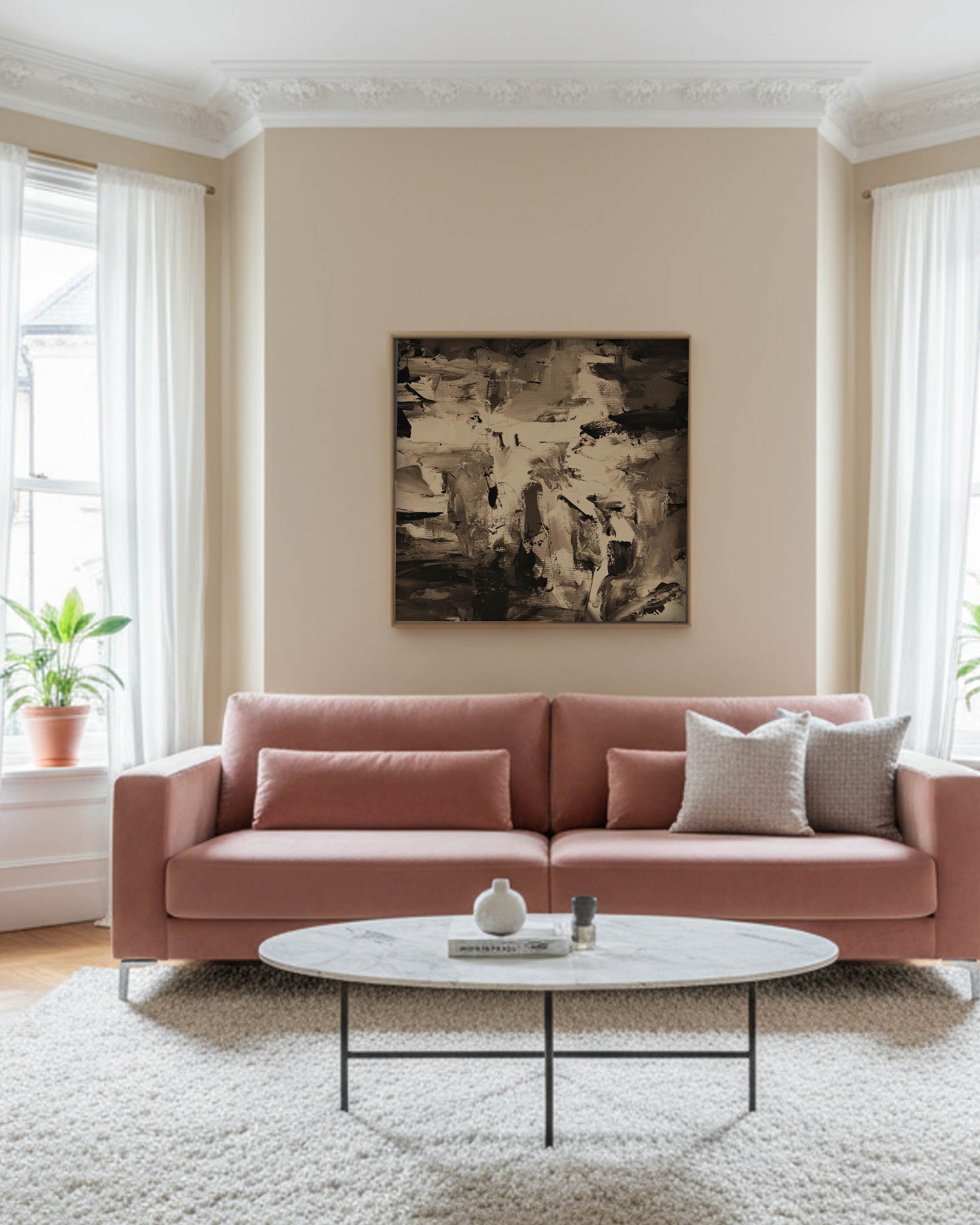 Living room with a pink sofa, white coffee table, and abstract art on the wall.