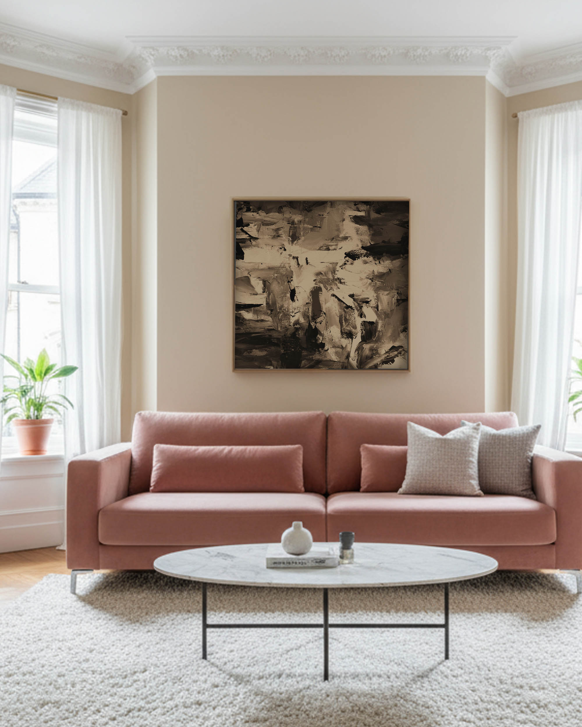 Living room with a pink sofa, white coffee table, and abstract art on the wall.