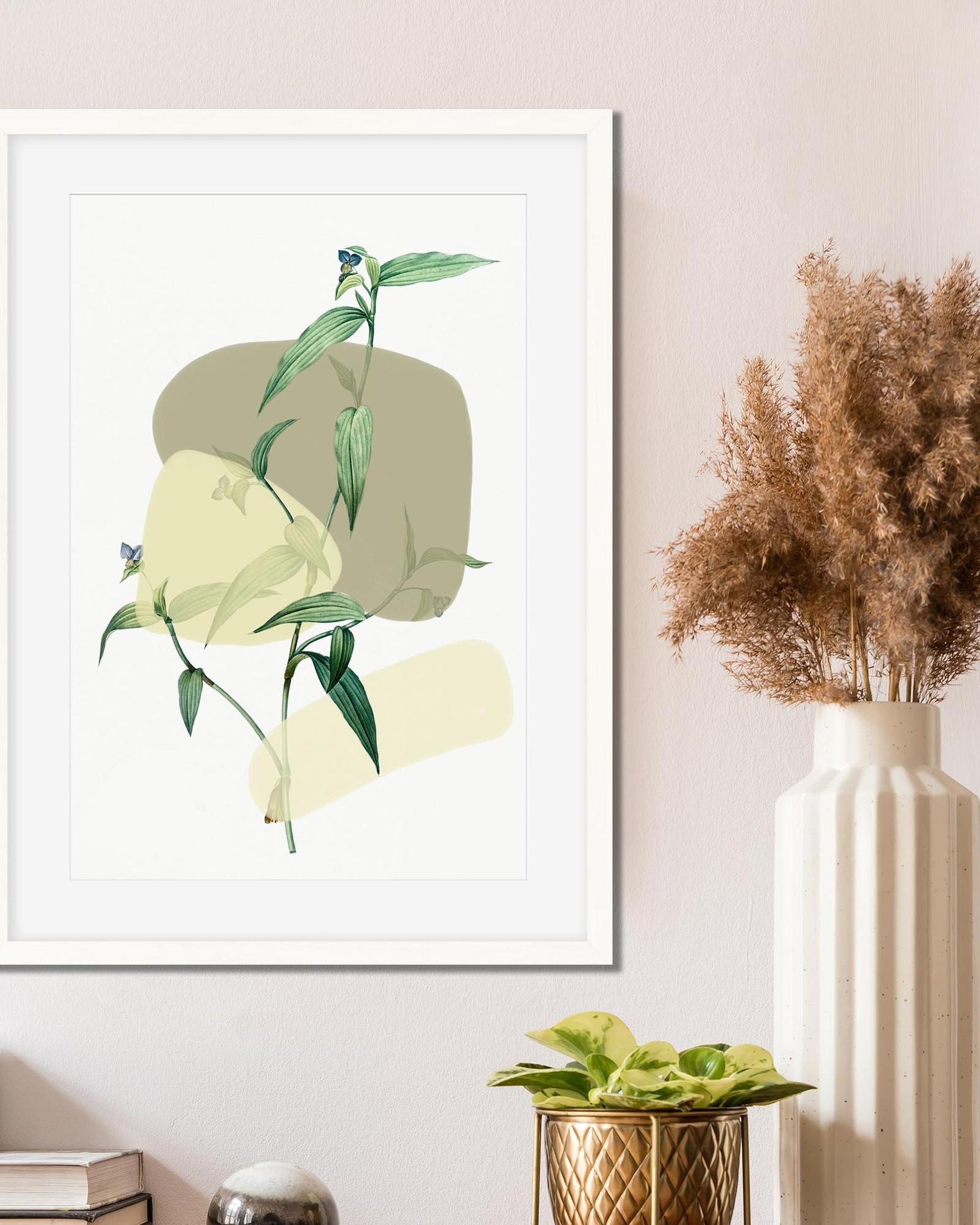 Framed botanical art print on a wall with decorative plants.