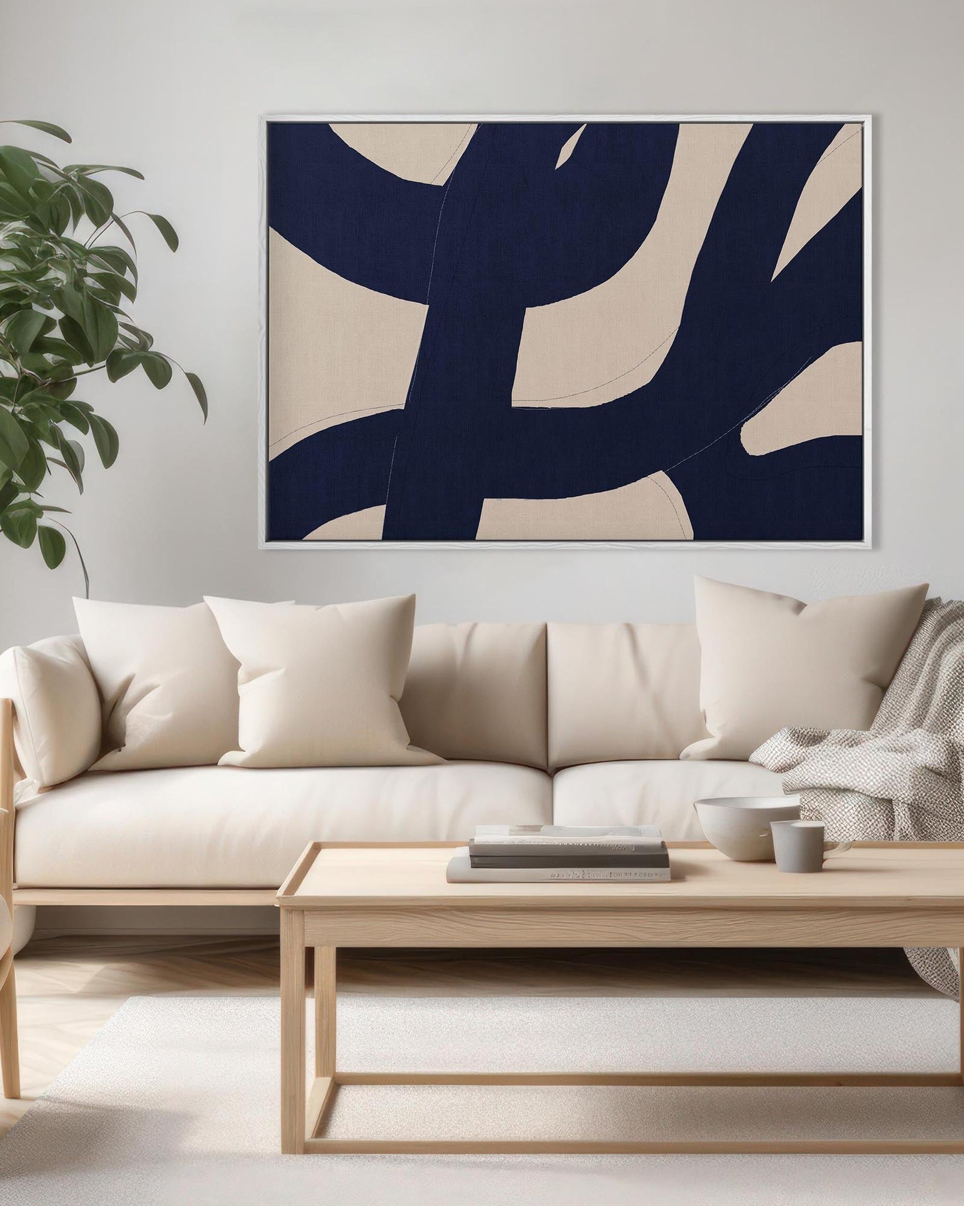 Modern living room with a beige sofa, wooden coffee table, and abstract art on the wall.