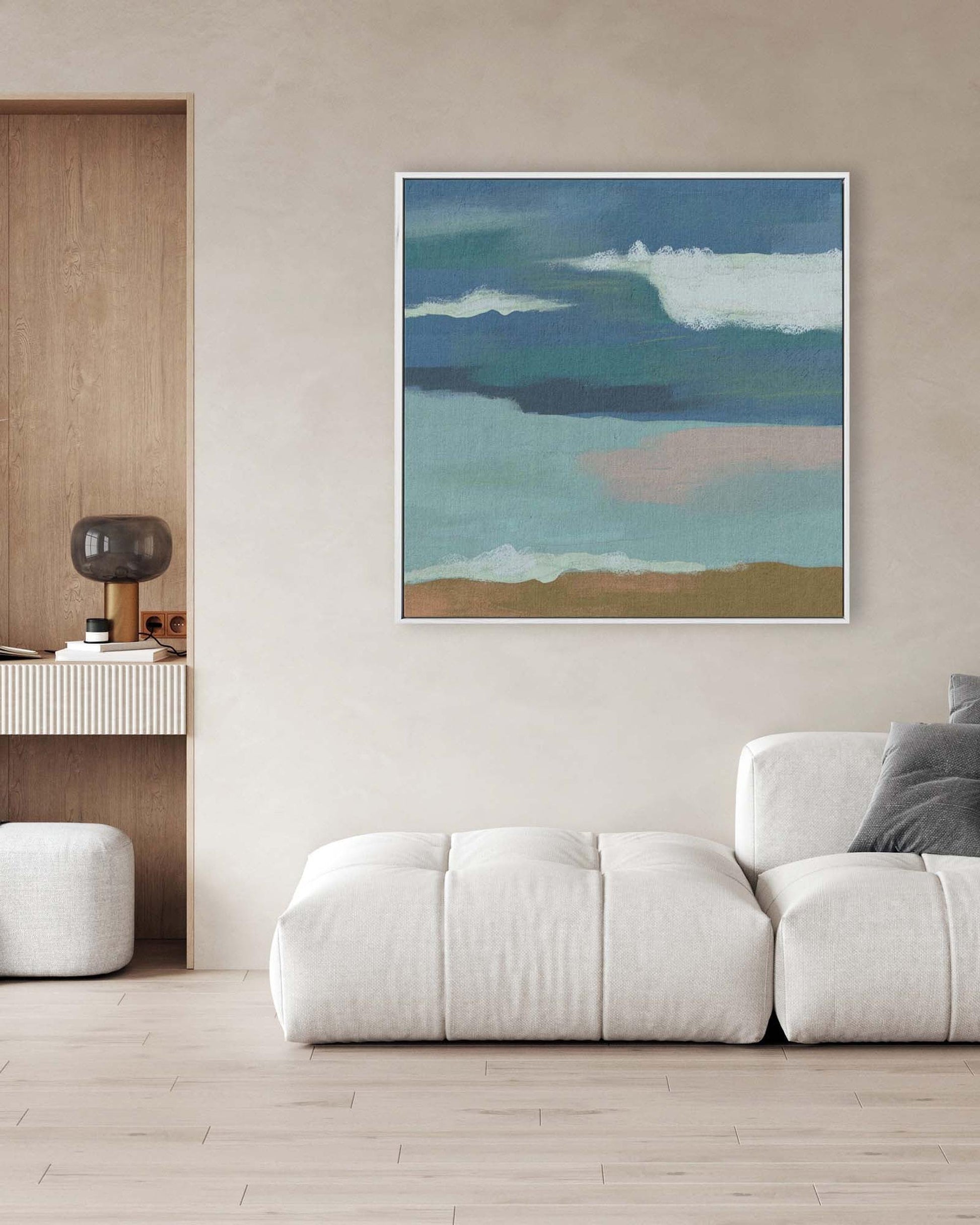Abstract painting on a wall above a white sofa in a modern living room.