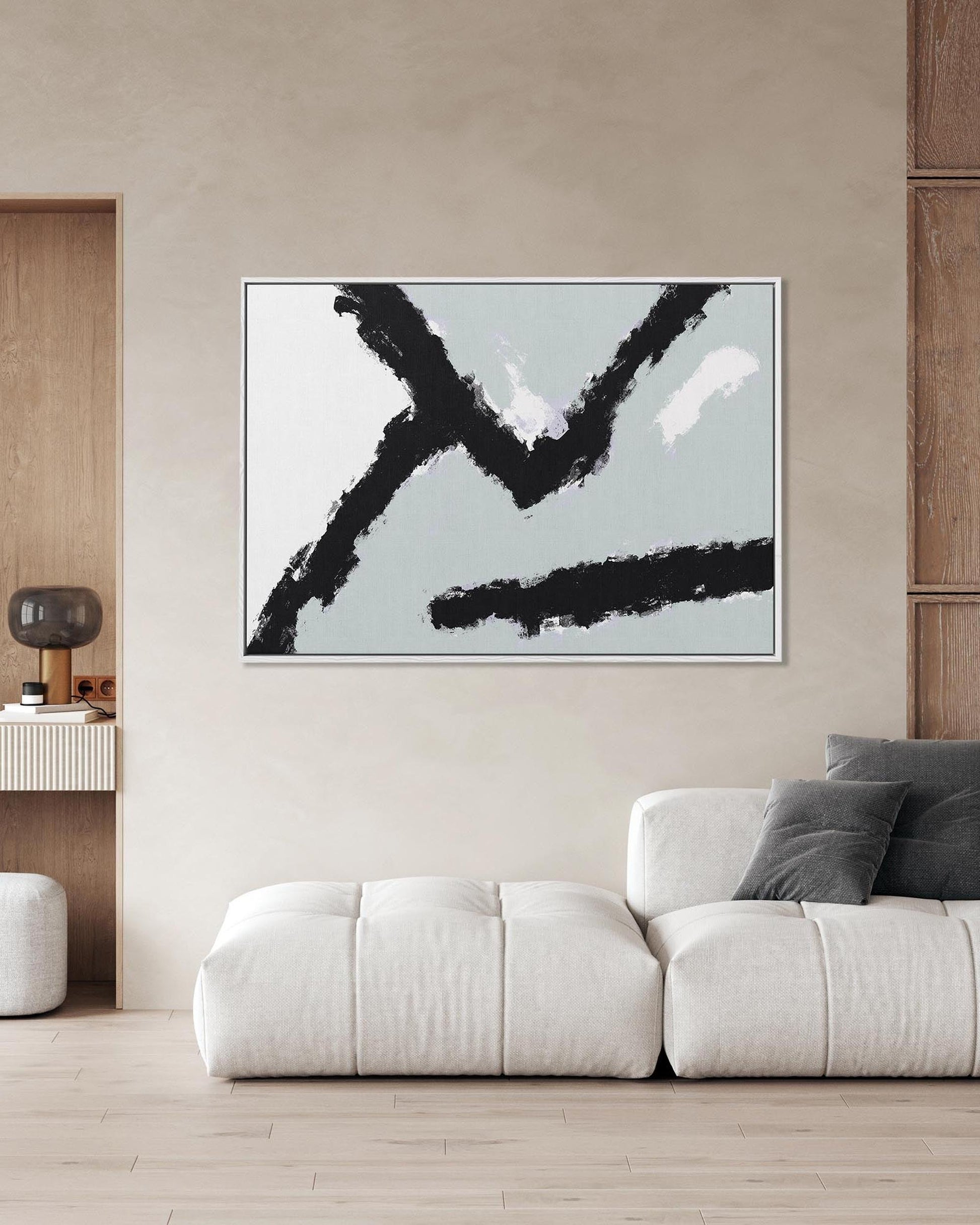 Abstract art piece on a wall above a sofa in a modern living room.