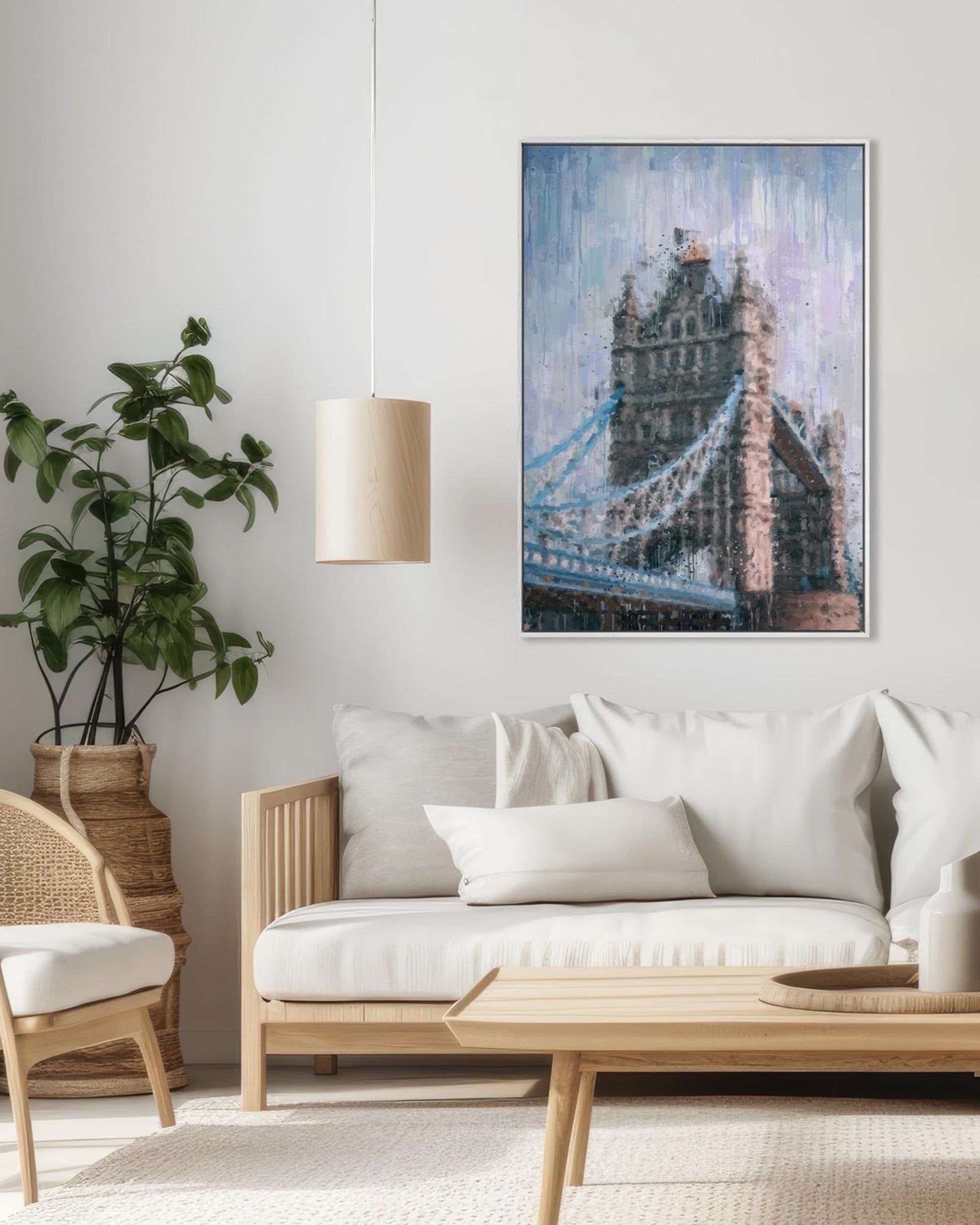 Living room with a white sofa, wooden coffee table, and a framed picture of Tower Bridge on the wall.