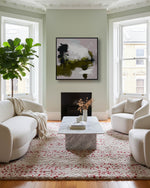 Modern living room with white furniture, marble coffee table, and abstract art on the wall.