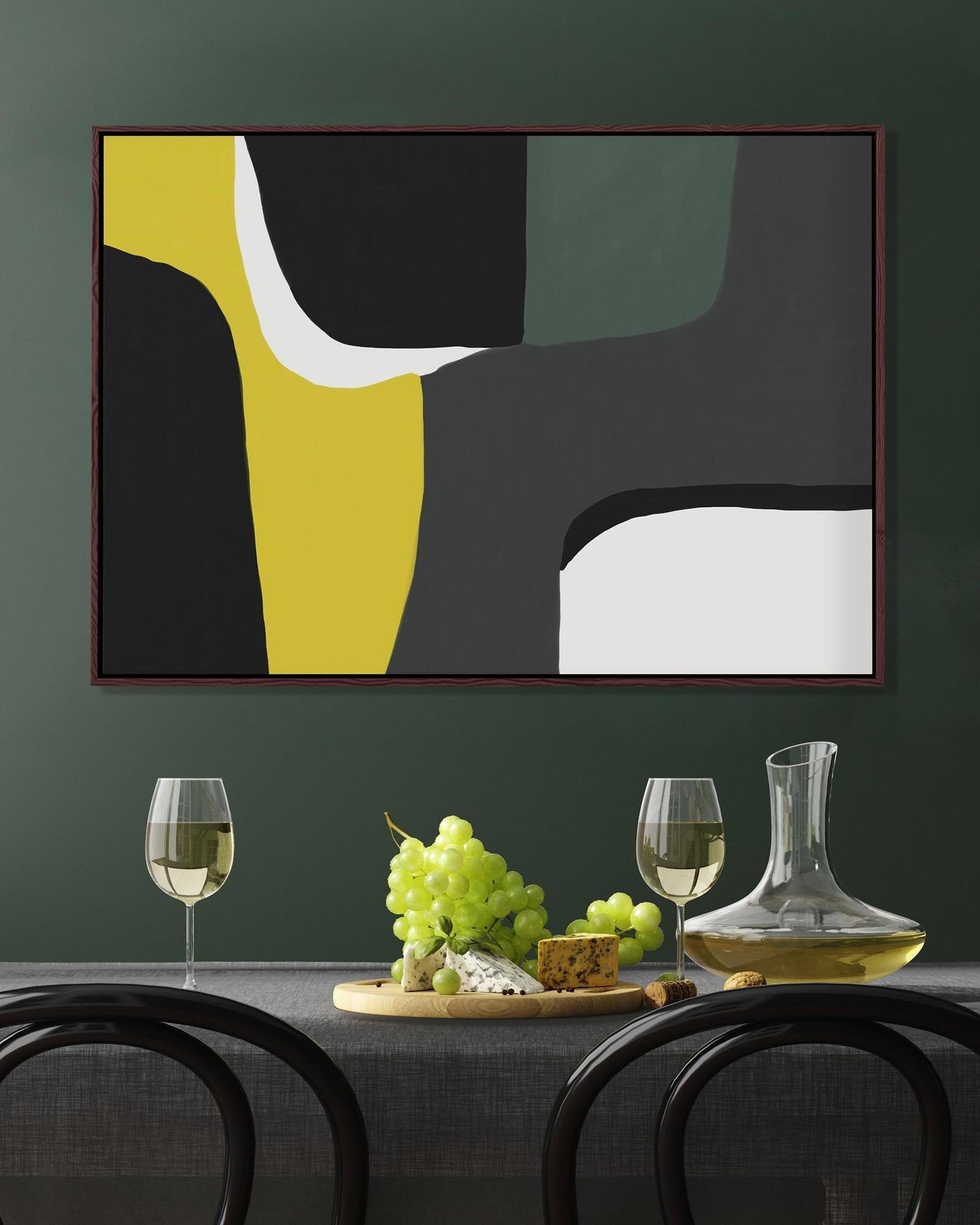 Abstract art piece on a wall above a dining table with wine glasses and grapes.