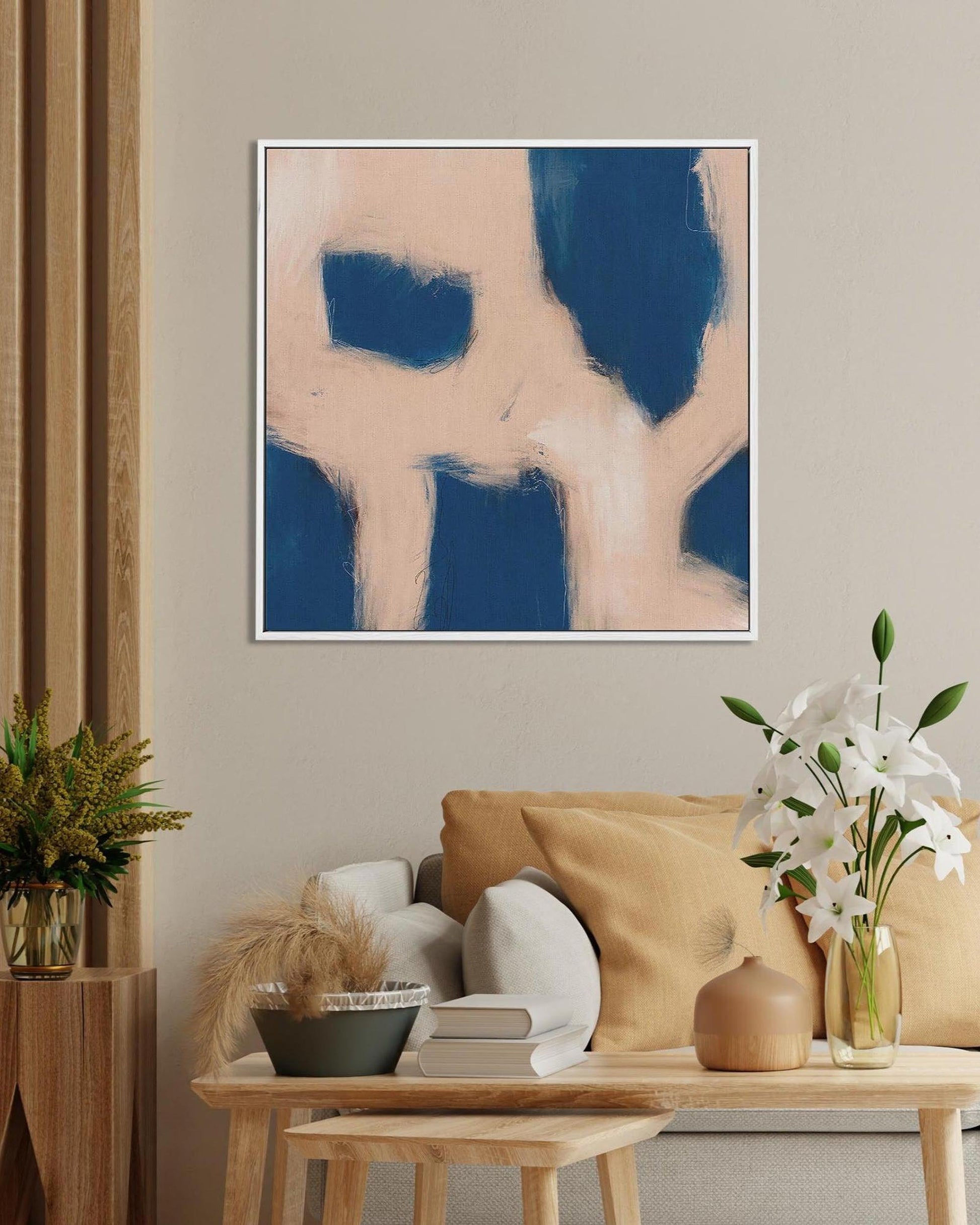 Abstract art piece on a wall above a living room setup with a couch and coffee table.